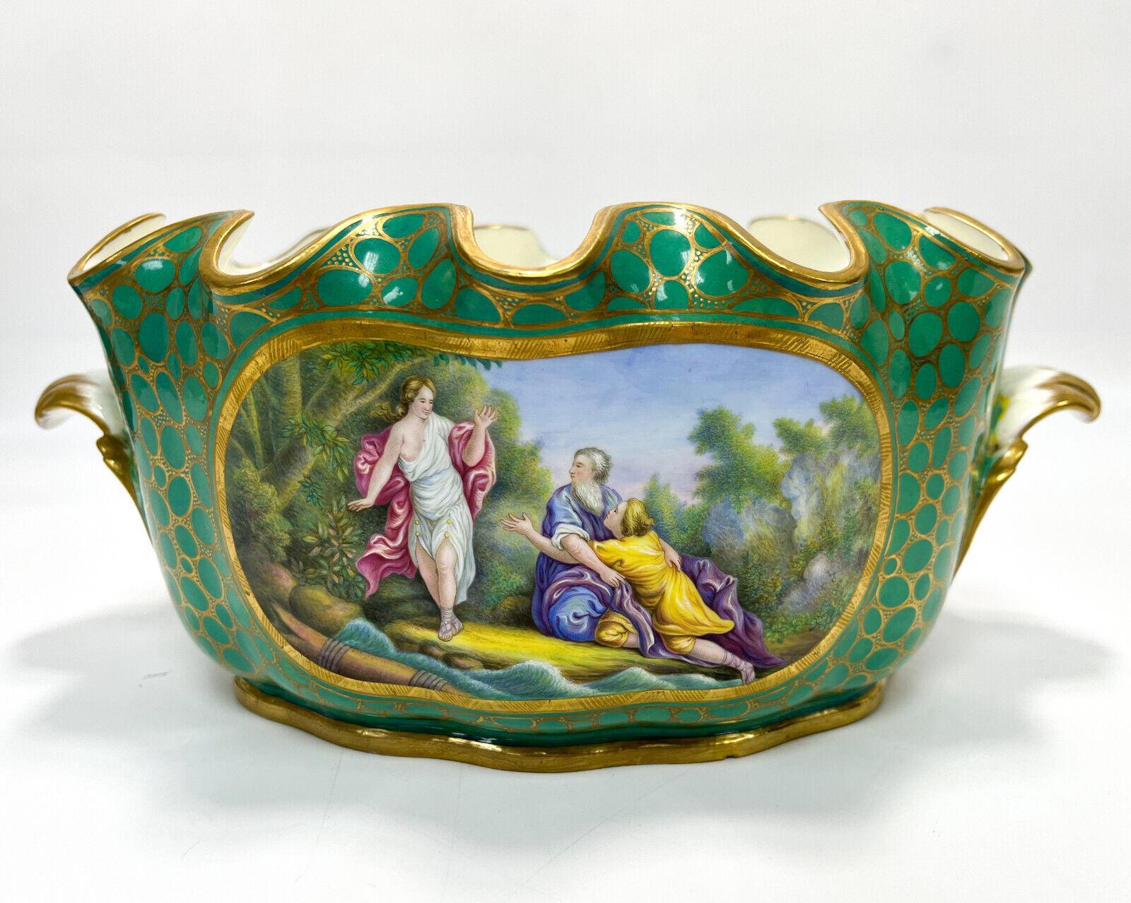 Sevres France hand painted Porcelain Monteith bowl, 19th century

A green ground with gilt cartouche decoration framing scenes of figures in classical dress to each side. Foliate handles, a scalloped rim. Underside with Sevres mark.

Additional