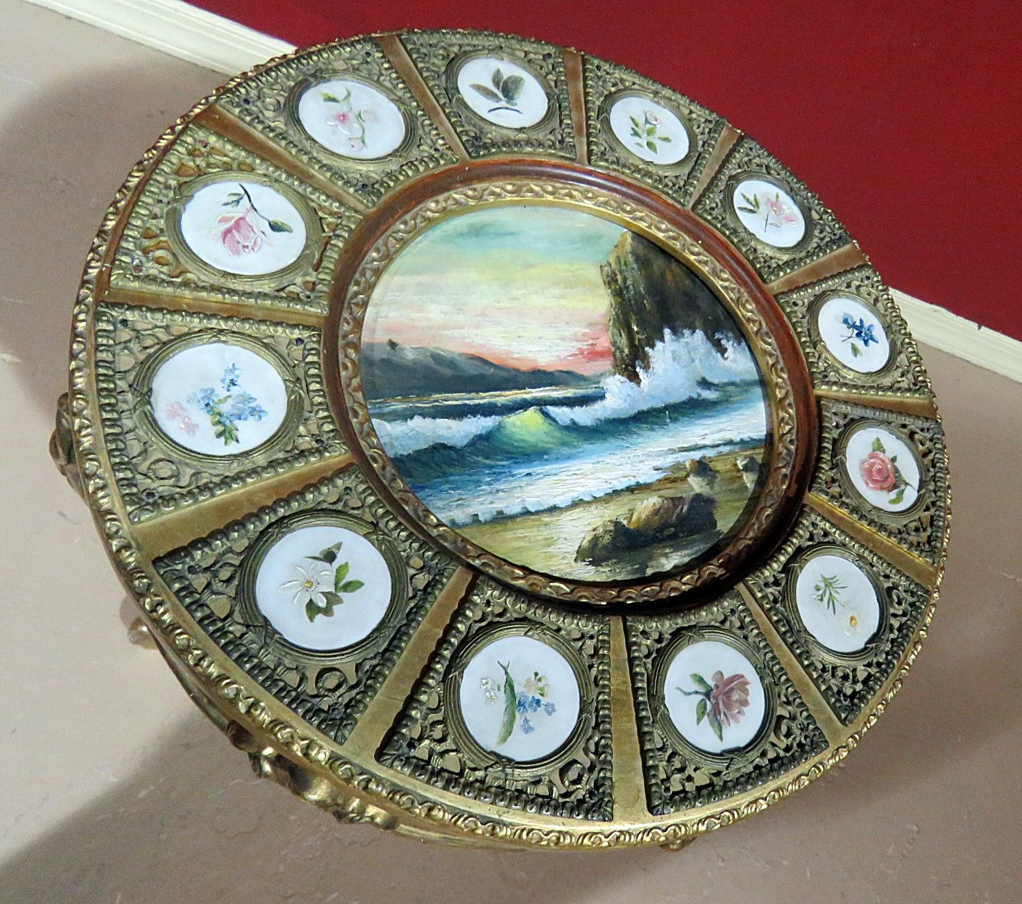 Sevres gilt decorated occasional table with inset painting in the center and 12 porcelain plaques.