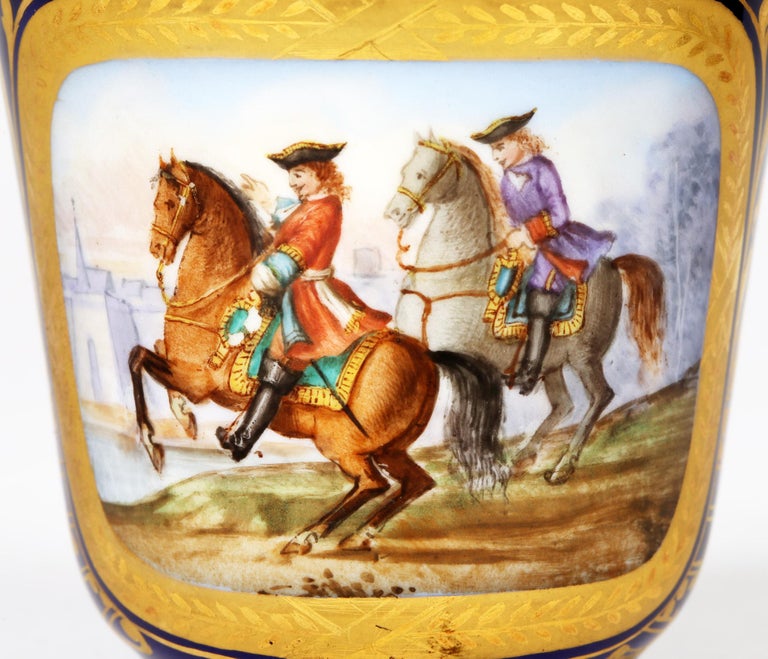 A fine antique French matched hand painted porcelain cabinet cup and saucer painted with various scenes by Sevres and dating from the latter 19th century. The finely made pieces comprise of a cup with molded loop handle and the body painted with a