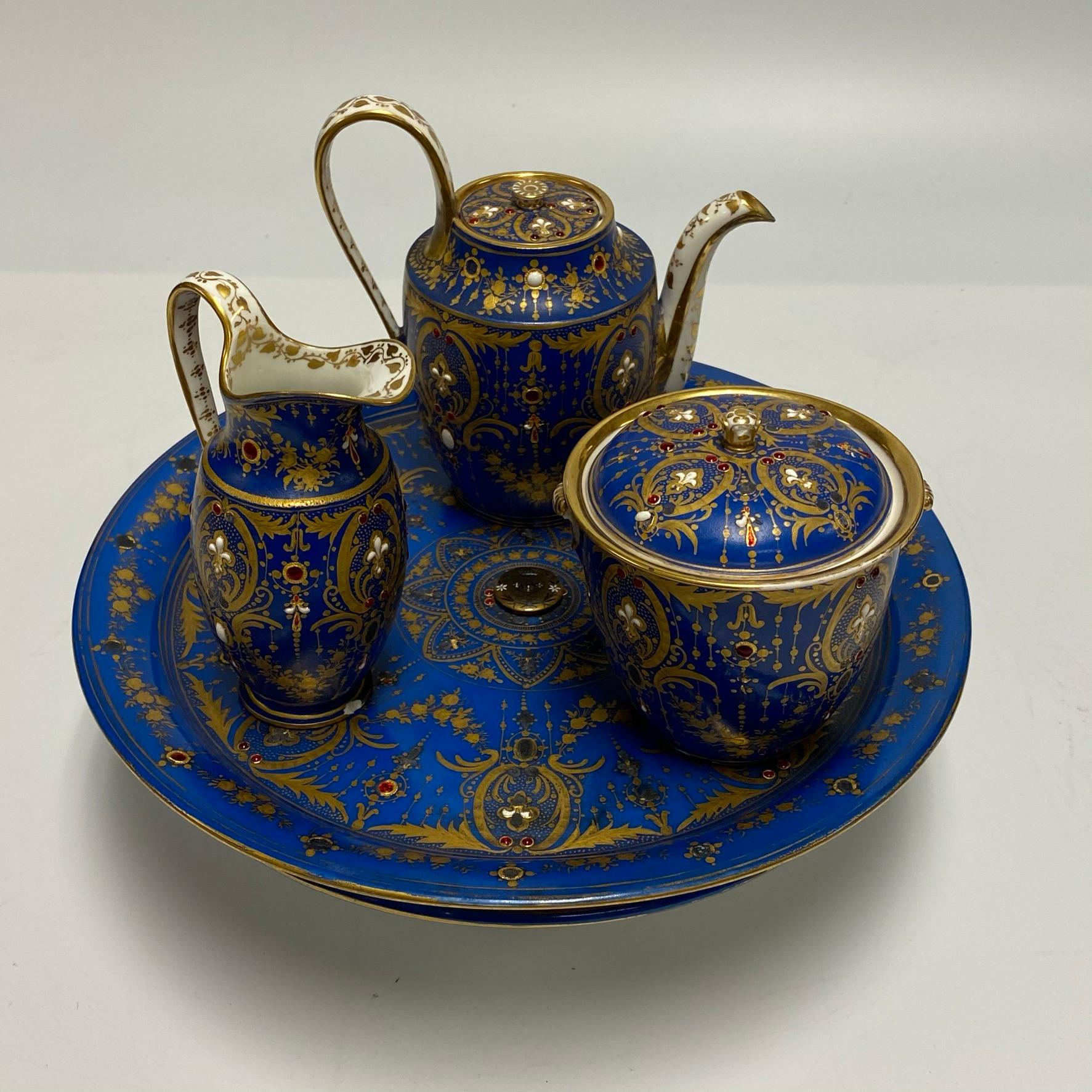 Very fine and unusual French 19 century Sevres jeweled porcelain tea service consisting of 
A tazza, sugar, creamer and tea pot.
Tazza: 12 7/8 in diameter, 4 in height.
Pot: 6.5 in height.