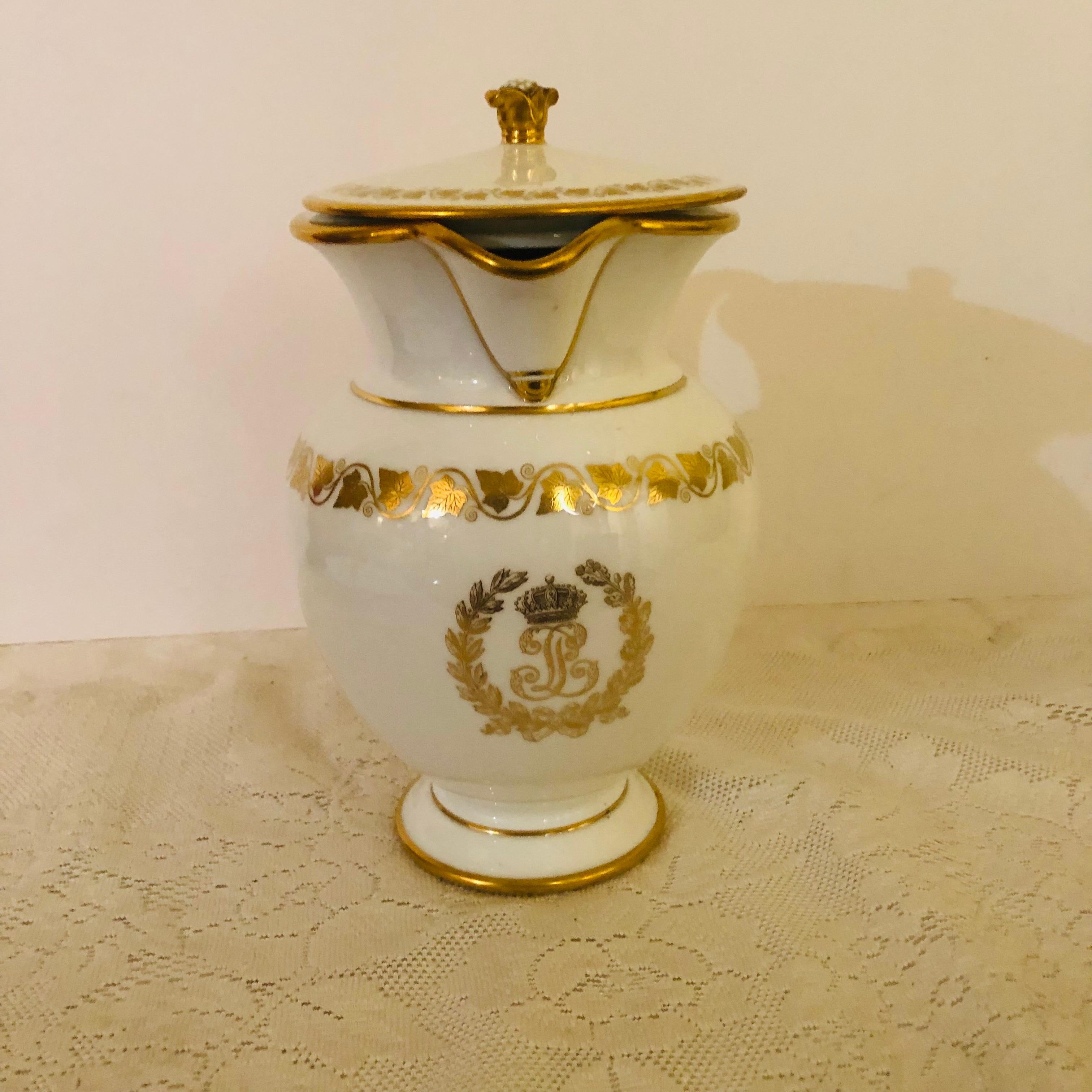 This is a fabulous, rare Sevres covered pitcher with white ground that has an elegant central gold monogram for King Louis Philippe made for his Chateau de Trianon. The gold monogram LP is surrounded by a gold foliate leaf wreath. Above the monogram