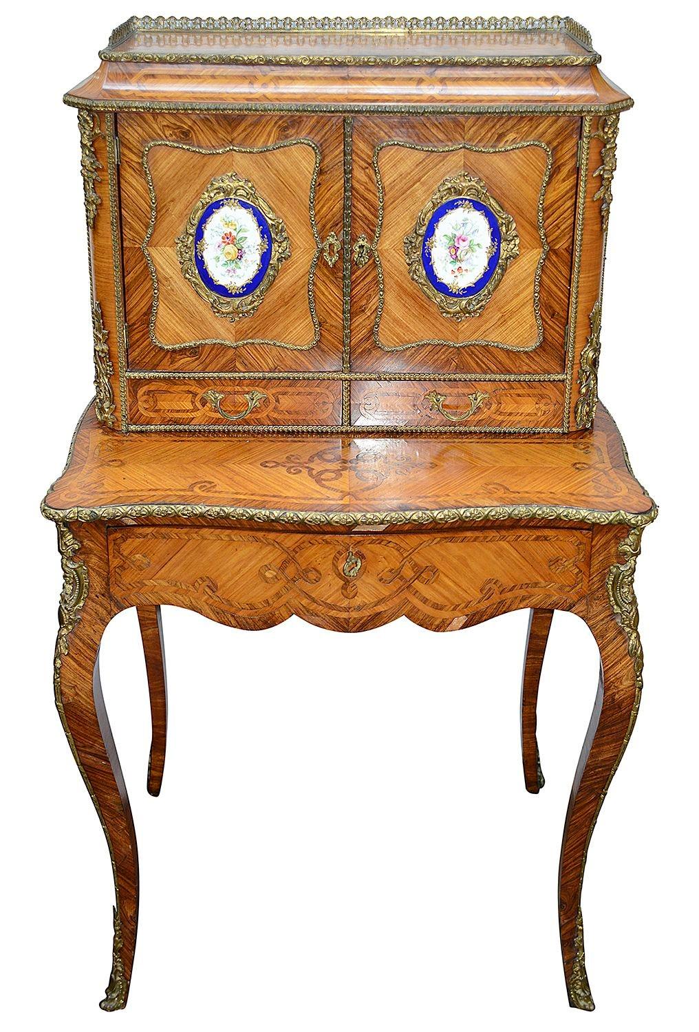 A very good quality late 19th Century French Louis XVI style Kingwood Bonheur du Jour, having inset Sevres porcelain style plaques depicting flowers, quartered veneers to the doors and sides, gilded ormolu mouldings and mounts.Raised on elegant