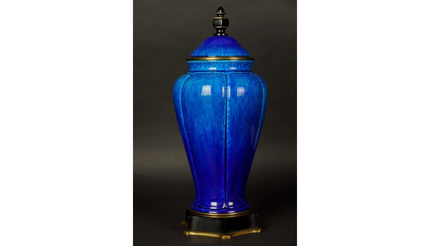 Sevres Paul Milet ceramic Art Deco cobalt blue urn or lidded vase
Vase of elongated shape, covered with a lid with a simple, geometric pinnacle. The surface of the vessel is divided into six equal panels separated by a nursery. The vase attracts