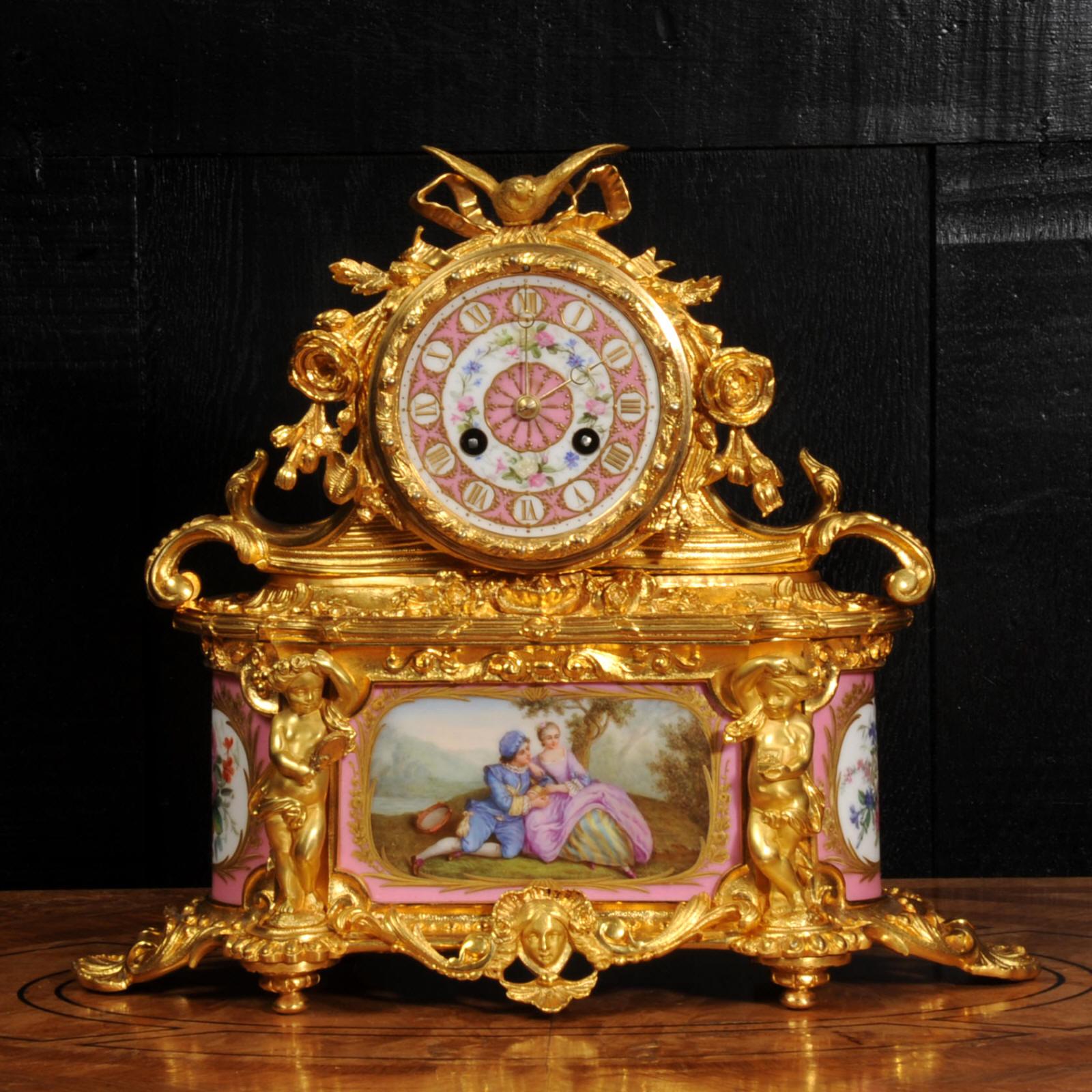 A beautiful original antique French boudoir clock, circa 1860. It is made of exquisite ormolu (finely gilded bronze) mounted with delicately painted Sèvres style porcelain with a pompadour rose pink ground. The panel below the dial is finely painted