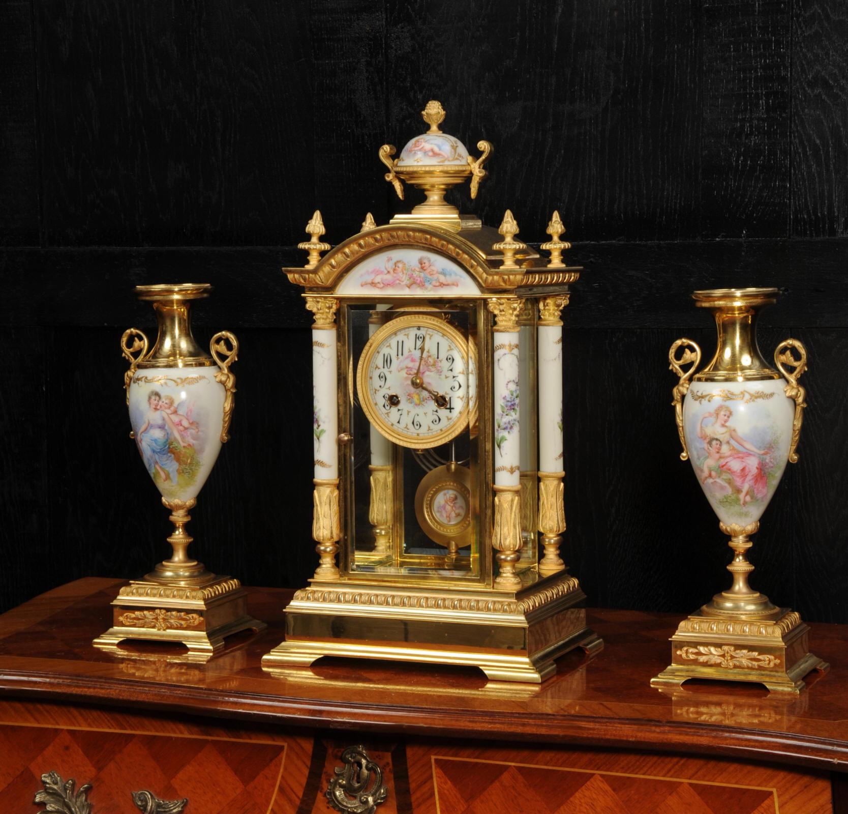 A rare and beautiful antique French clock garniture, in excellent original condition. Ormolu (fine gilded bronze) is mounted with exquisitely painted Sèvres style porcelain. Porcelain is very finely painted with maidens and putti on a cream ground.