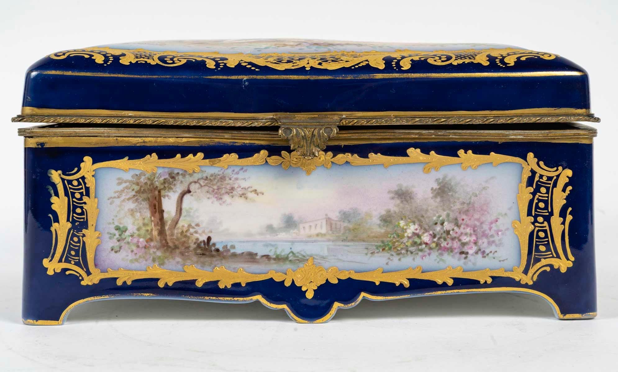Sèvres porcelain box, 19th century, Napoleon III period.

A 19th century Napoleon III period Sèvres porcelain box, Chateau des Tuilleries, gilt brass mounting.

H: 12cm, W: 25cm, D: 18cm