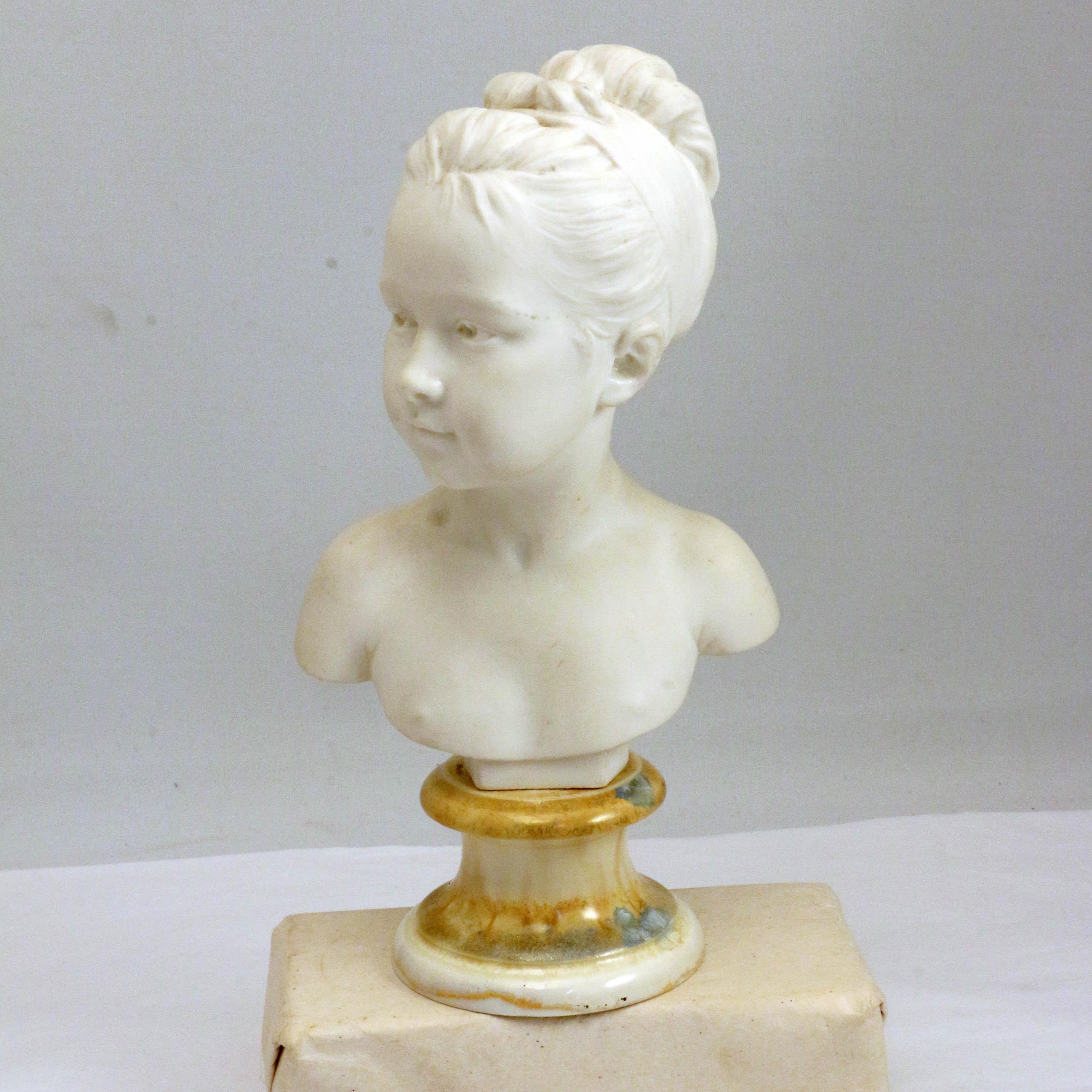This ever popular subject, a pretty girl, has never been done better than Houdon's study of Louise de Brognard. This charming version by Sevres is well-modeled, bisque and on a simulated marble socle.