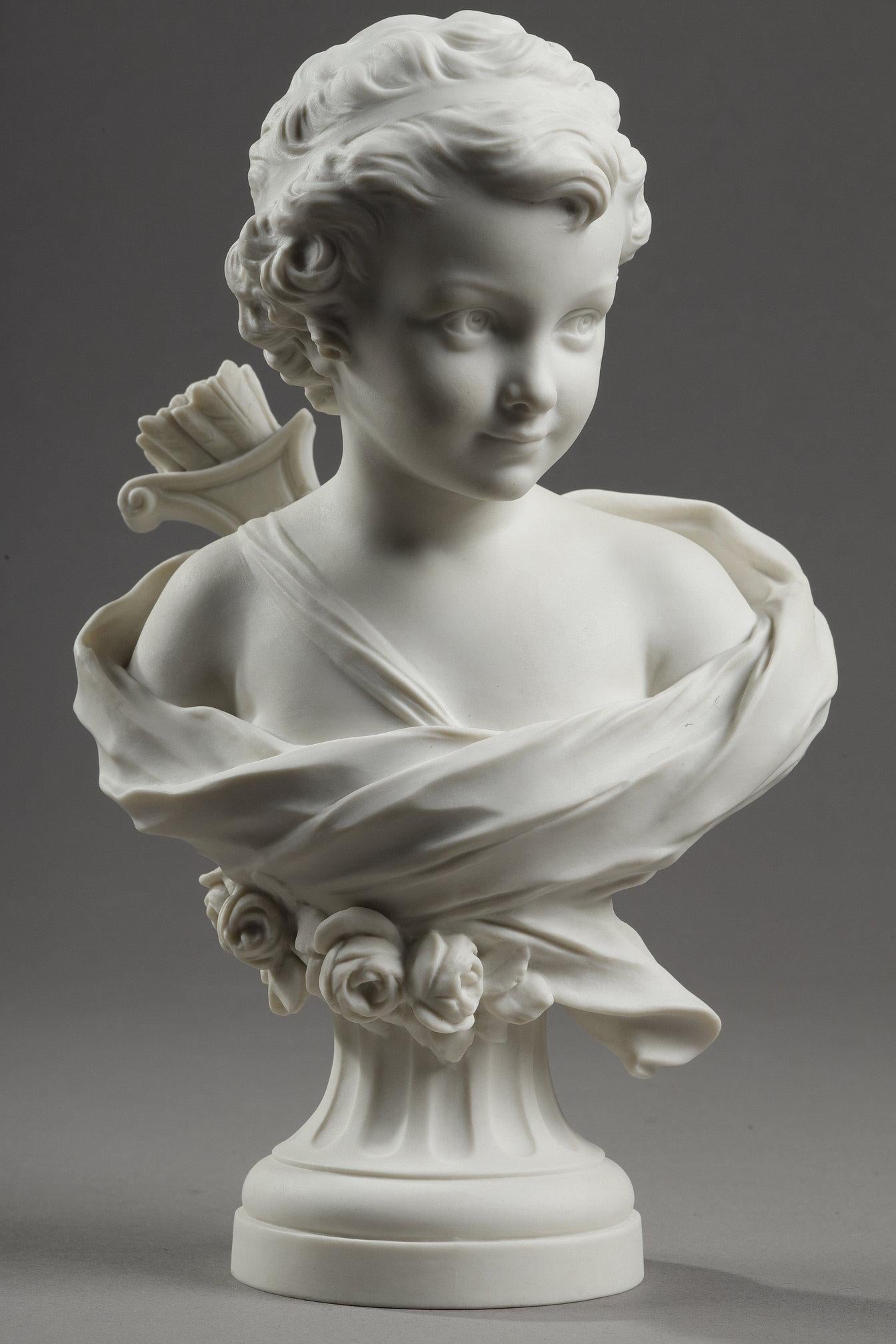 Small bust of Cupid in biscuit signed Agathon Léonard (1841-1923) and stamped Manufacture de Sèvres, dated 1926. It depicts a young putto carrying a quiver on his back. A drape covers the cupid's shoulders. The sculpture's circular base is fluted