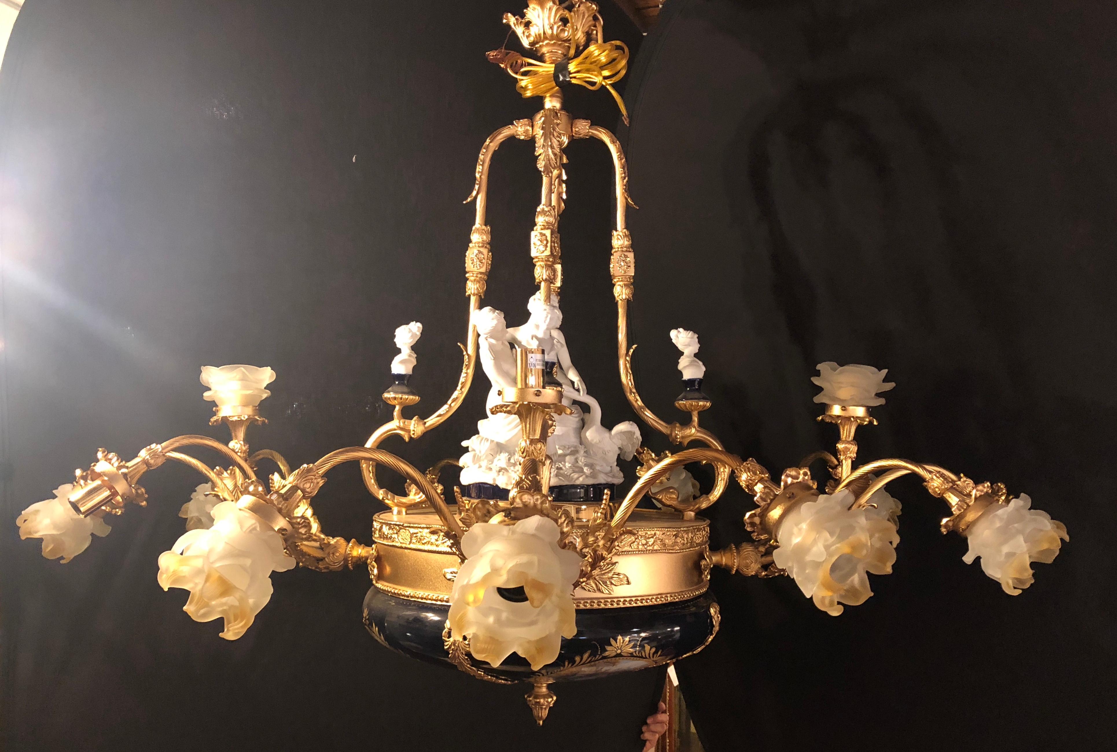 A Sèvres style 16-light palatial bronze and porcelain chandelier. This newly rewired lighting fixture comes with a 60 inch chain and matching canopy. The Central Sevres bisque figure is 12 inches in height depicting a finely sculptured Diana The