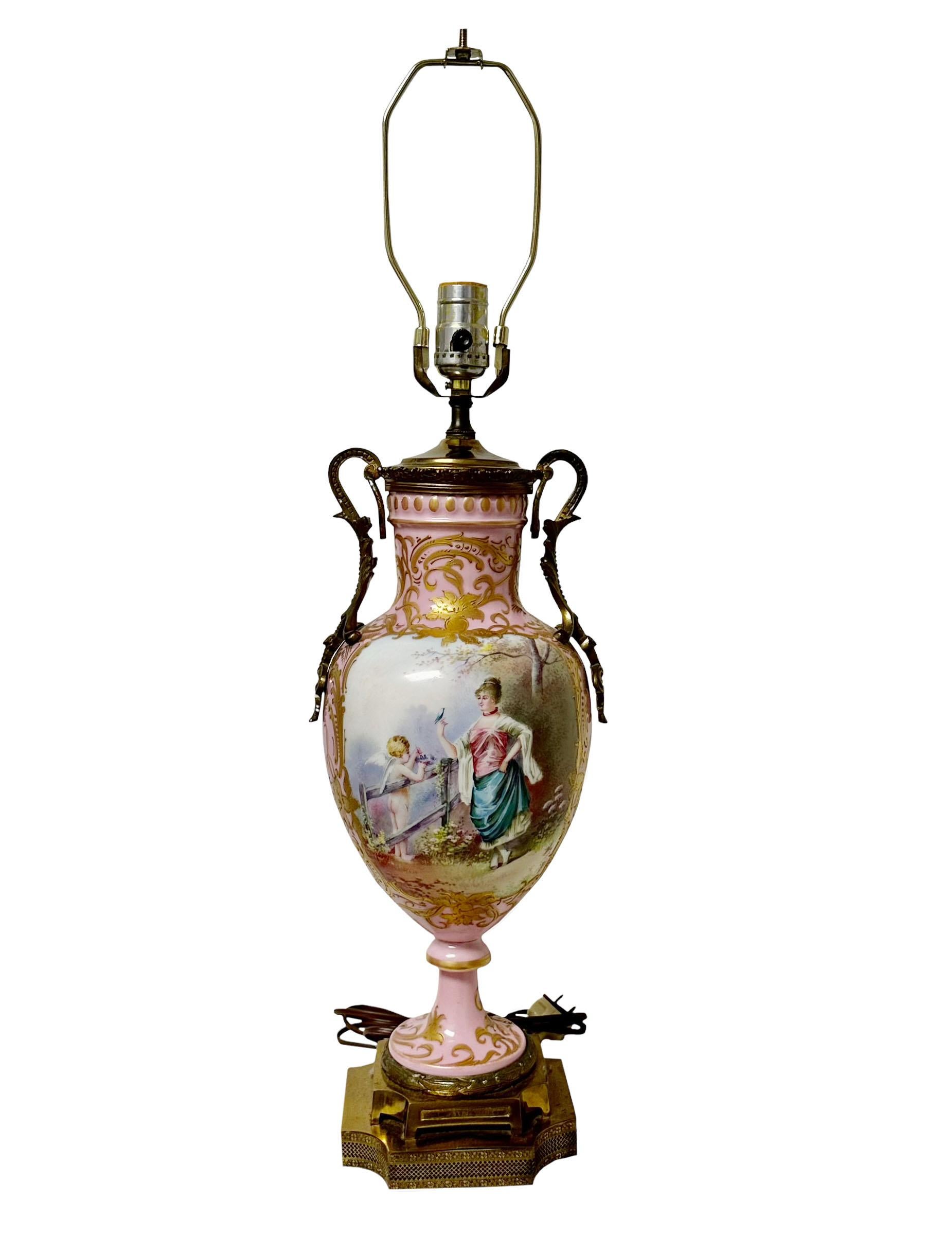 A late 19th century Sevres porcelain cast or a vase that has been converted into a lamp. It's hard to tell if it were a cast or a vase because it has an ormolu cap on it. Lamp with art nouveau flowers in the back and cut corners on the base.
