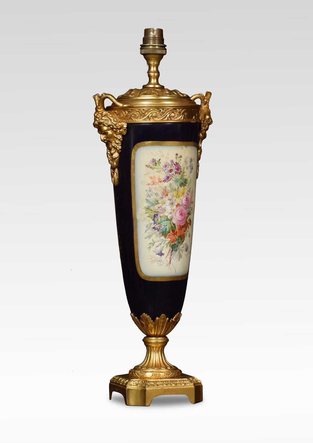 Sevres style French porcelain and ormolu table lamp, of baluster form with swags and fawn masks, to the finely painted center with courting couple to one side and flowers to the reverse. Enclosed by a gilt border all raised up on canted gilt metal
