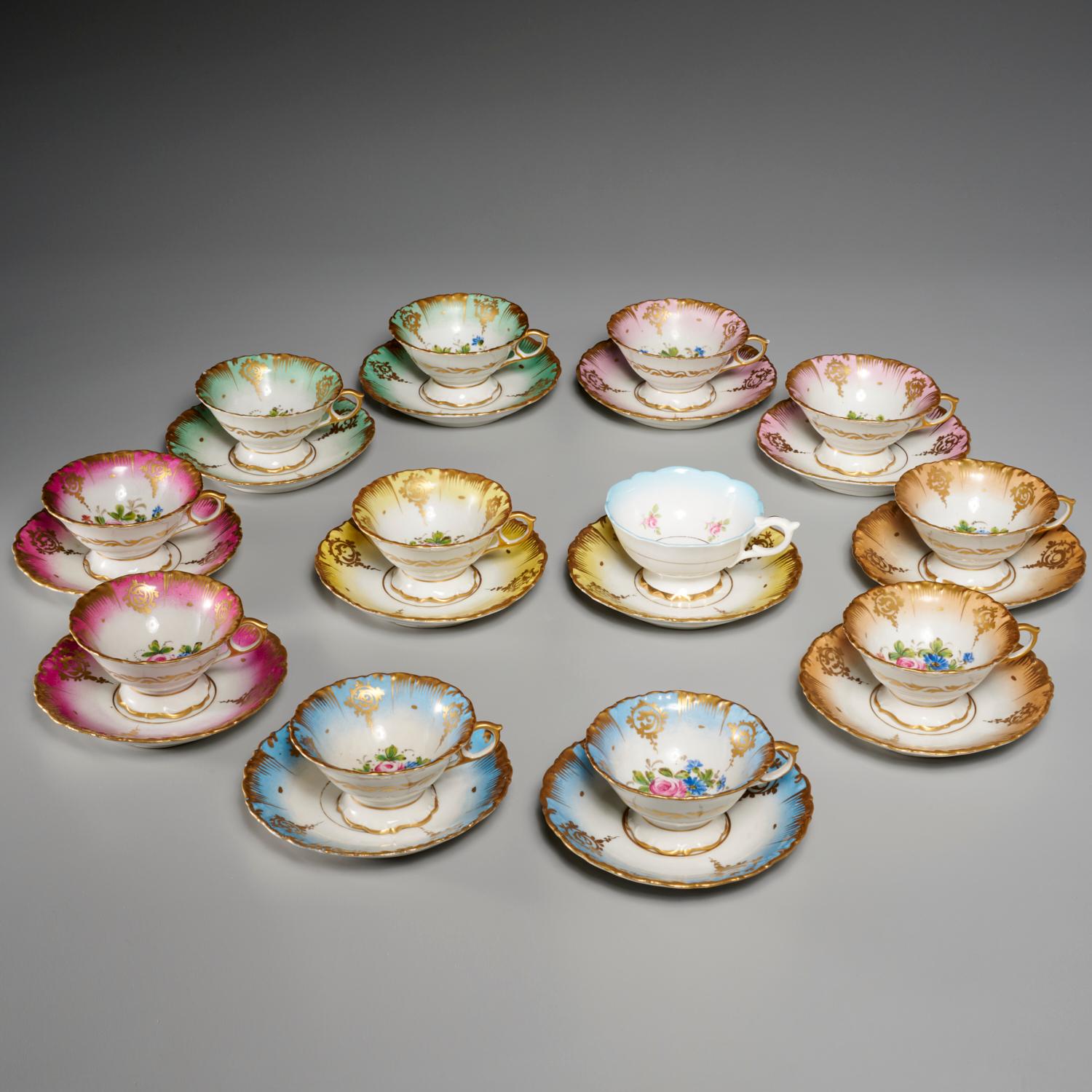 20th c., France, gilt and painted porcelain dessert service. The set is decorated with pink rose clusters on various color grounds and gold accented scallop moulded borders. 

Dimensions and quantity:
Set comprises: 
12 cups, 2