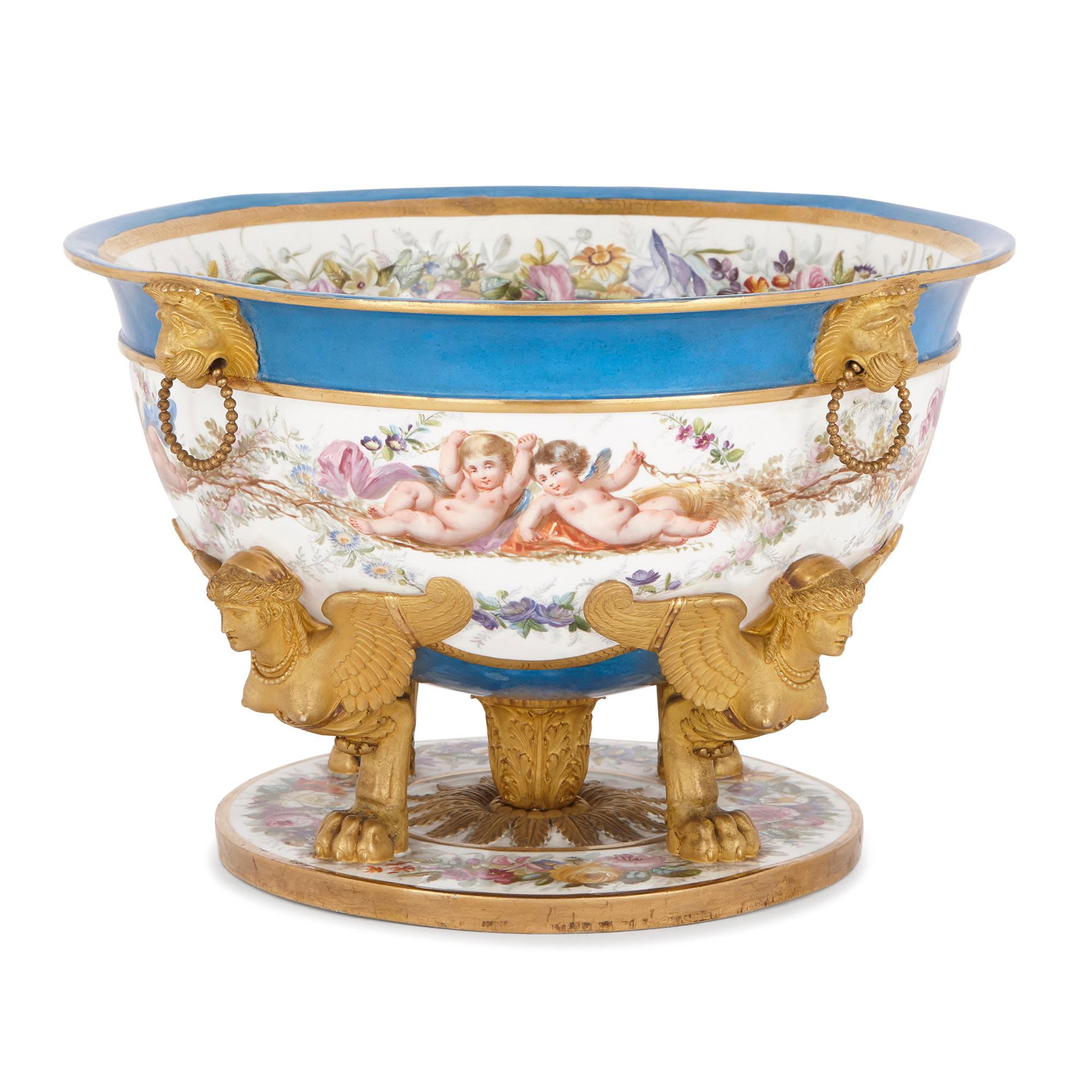 This exquisite centrepiece was crafted in the mid-19th Century in the fashionable Sèvres style. Sèvres style porcelain wares, like this piece, were often decorated with flowers, putti, exotic birds, pastoral and mythological scenes, and marine