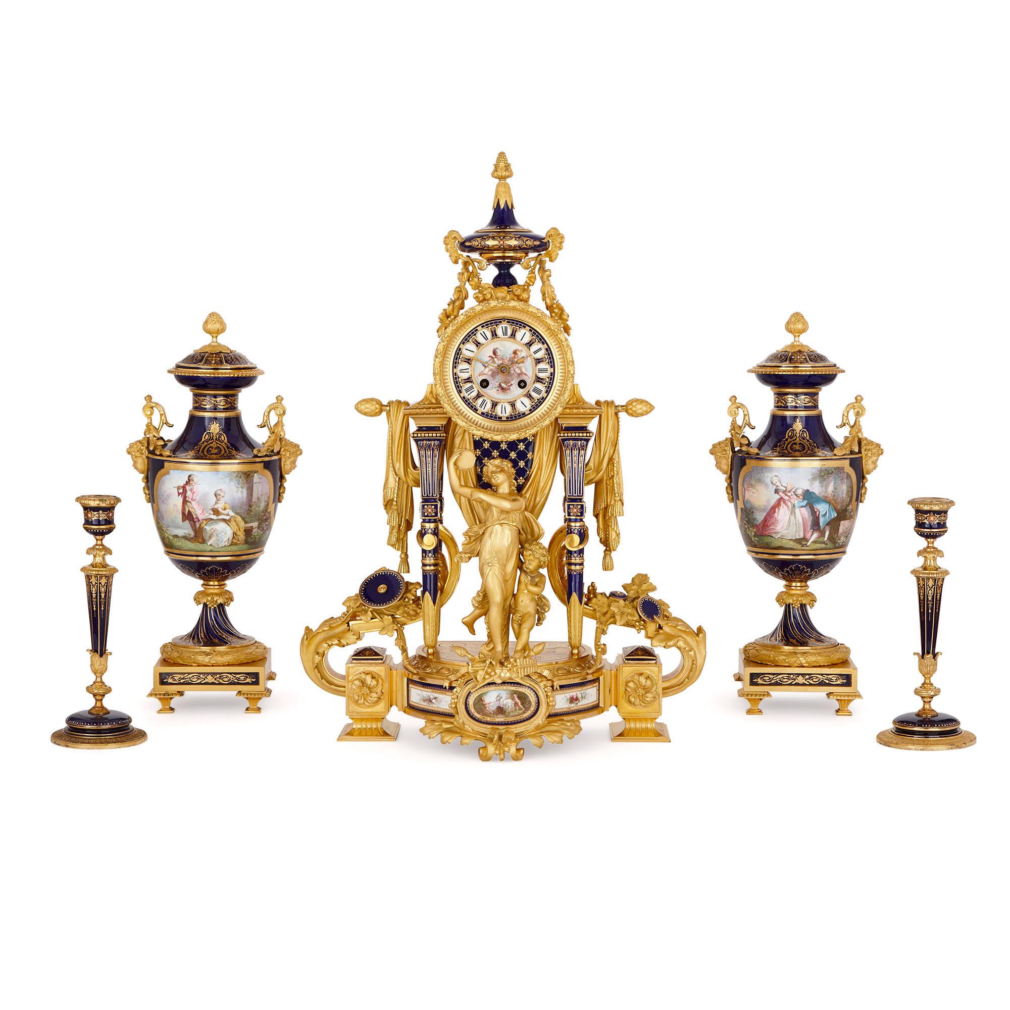 This magnificent five-piece clock set is designed in the style of 18th century porcelain produced by the famous Sèvres Manufactory in France. The set is comprised of a mantel clock, a pair of flanking vases—which double-up as candelabra—and two
