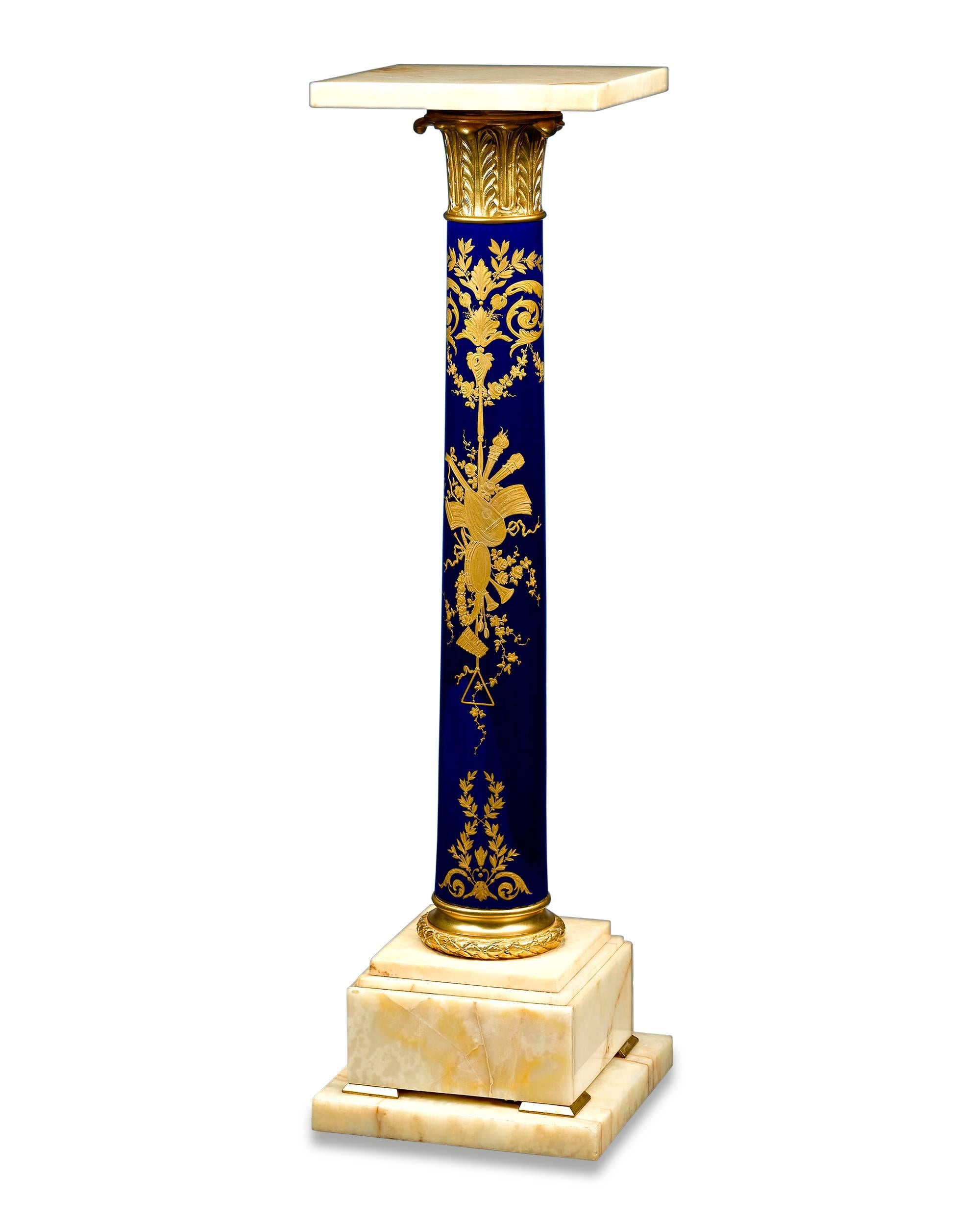 This outstanding pedestal beautifully exhibits the style and grace of the famed sèvres porcelain manufactory. This exceptional piece features a lustrous deep blue base, which provides the perfect background for the intricate gilt painting depicting
