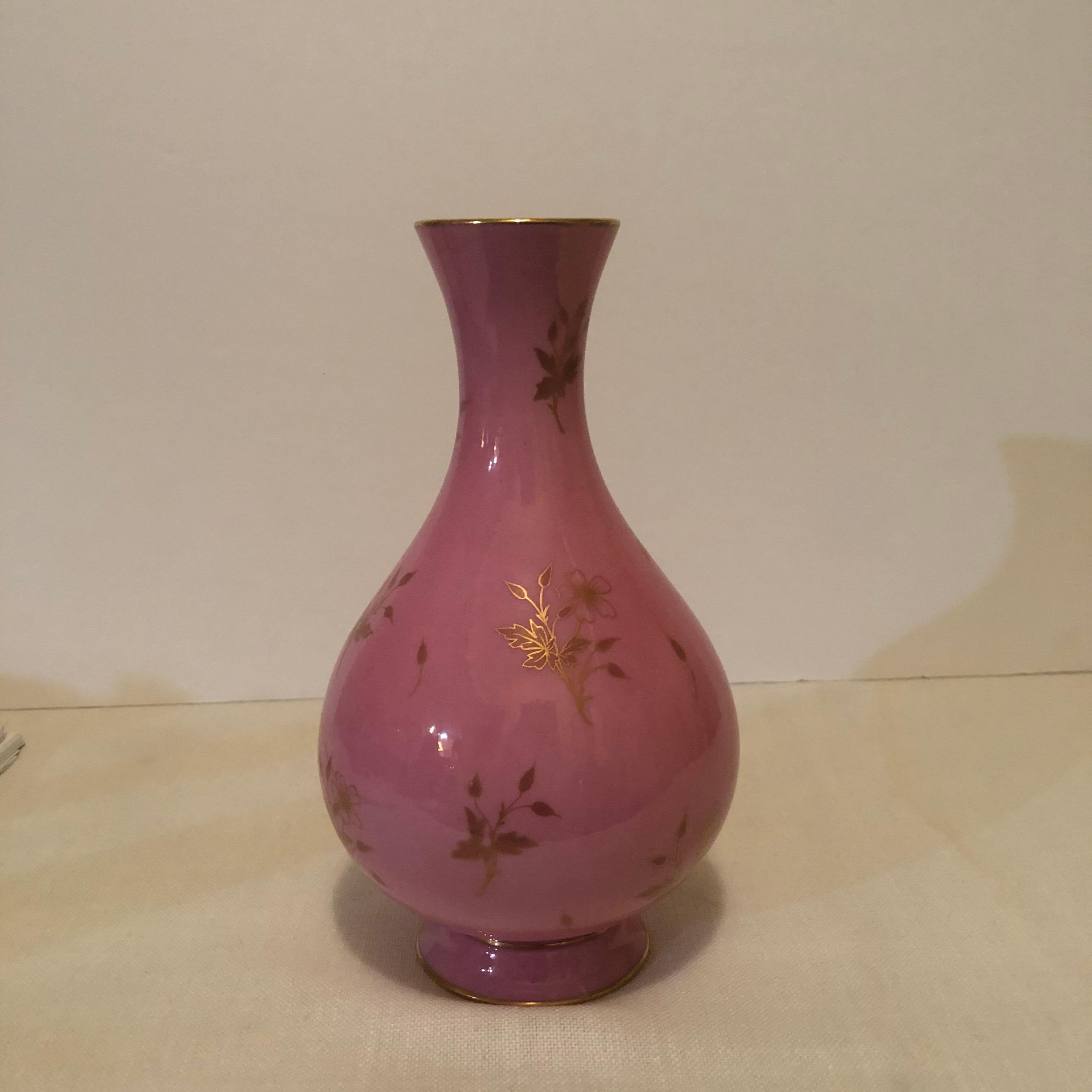 This is a lovely Sevres vase in the eye-catching pink pompadour color with painted accents of gold flowers. It is signed Dore a Sevres, 1898. The pink color was Madame de Pompadour's favorite color for Sevres porcelain. That is why it is called pink