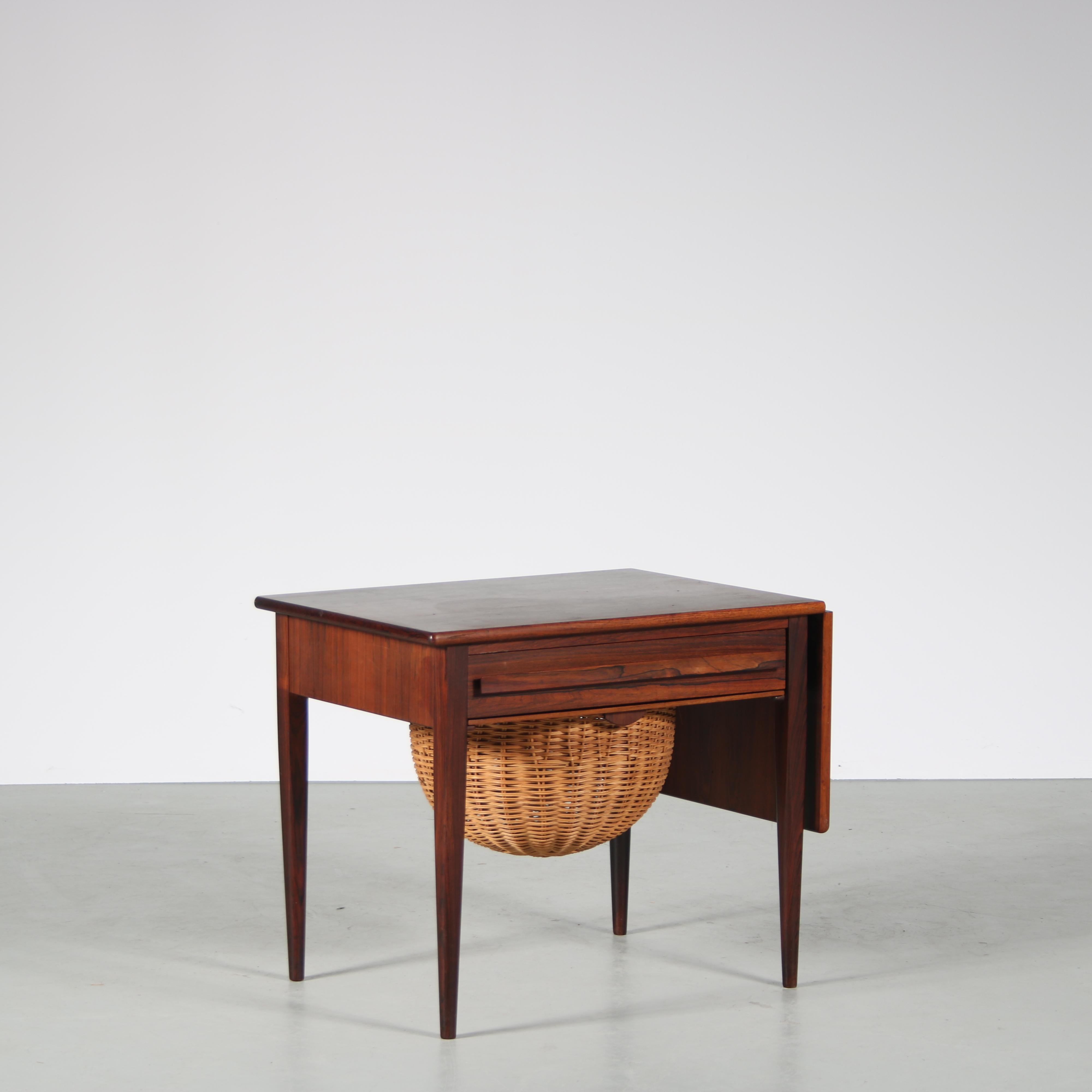 A beautiful sewing table, designed by Johannes Andersen and manufactured by CFC Silkeborg in Denmark around 1960.

The piece is made of high quality tropical hardwood, crafted with an impressive eye for detail and elegant shapes and finish. It has