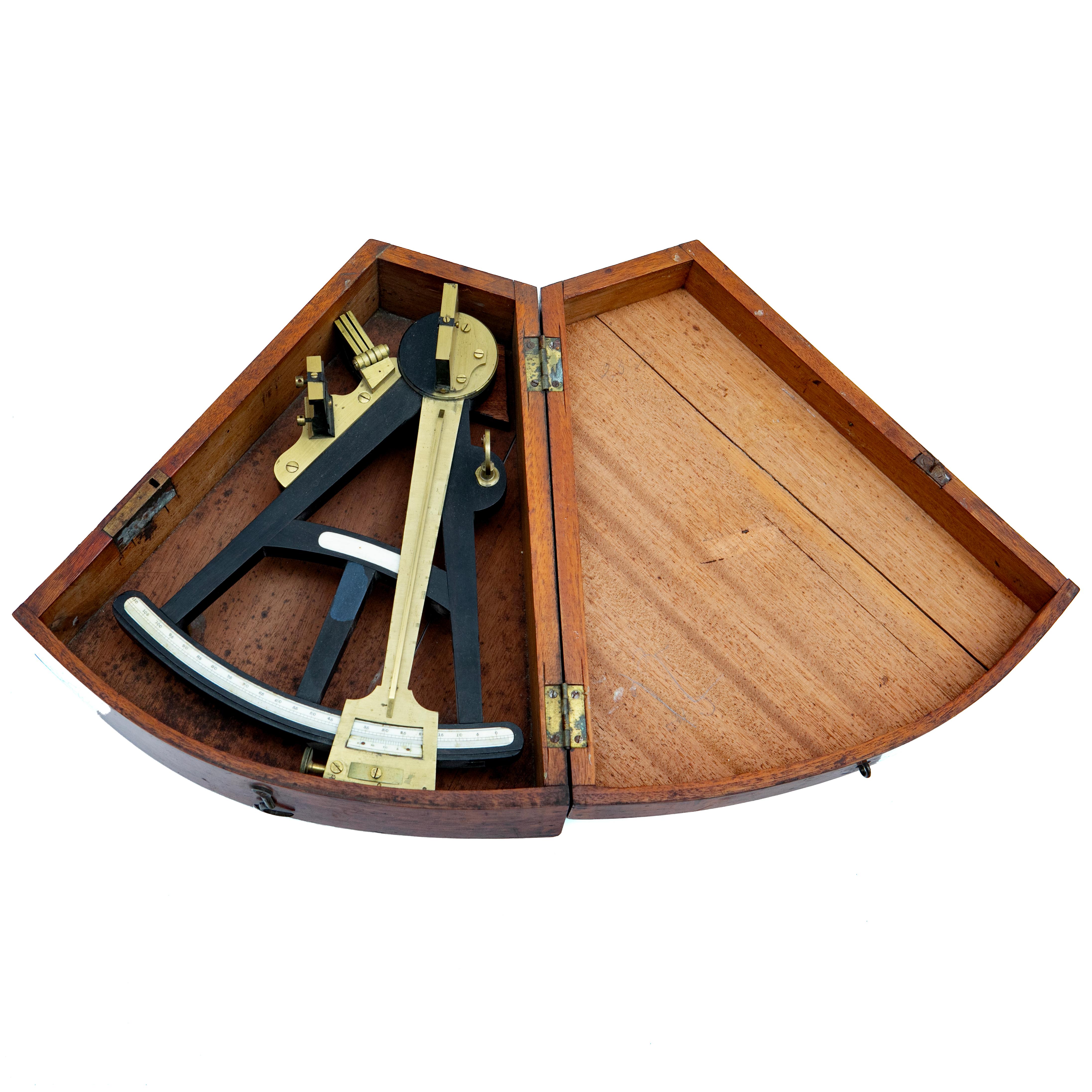 Sextant in Original Mahogany Case
This beautifully crafted sextant is presented in its original mahogany case. Made from brass, black wood, and bone,
It features finely engraved scales and tinted glass. The instrument has been preserved in its
