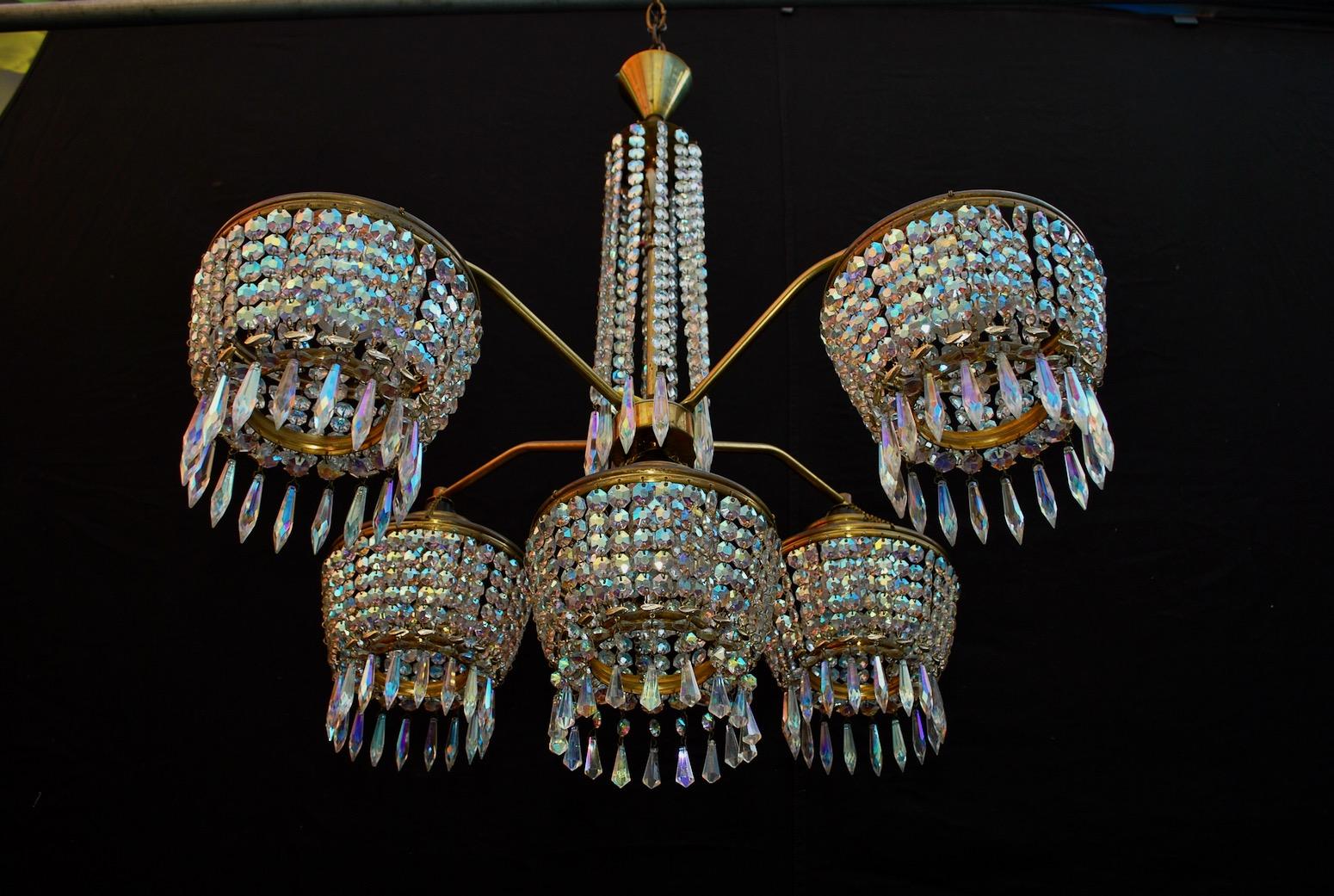 A sexy 1960s chandelier, I love this light, it has two worlds into, Classic and modern, the patina is much nicer in person, the crystal has some beautiful blue color into them, they give such beautiful sparkles.

  