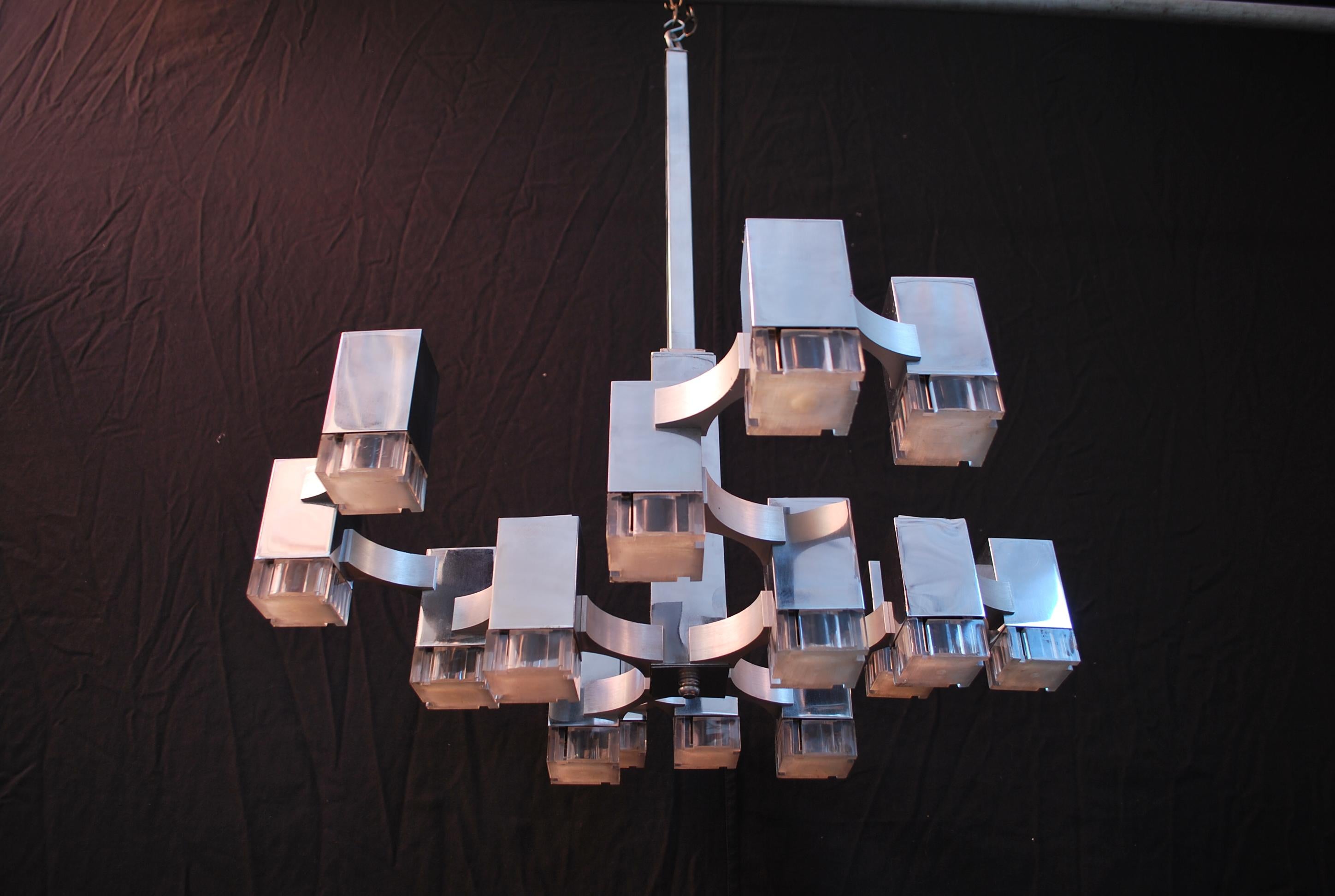A sexy 1970's Italian chandelier, design by the iconic designer Sciolari, the height of the chandelier can be shorter to almost a flush light, we could cut it for you, on the picture it is hard to see the two type of metal, a flat metal color and a