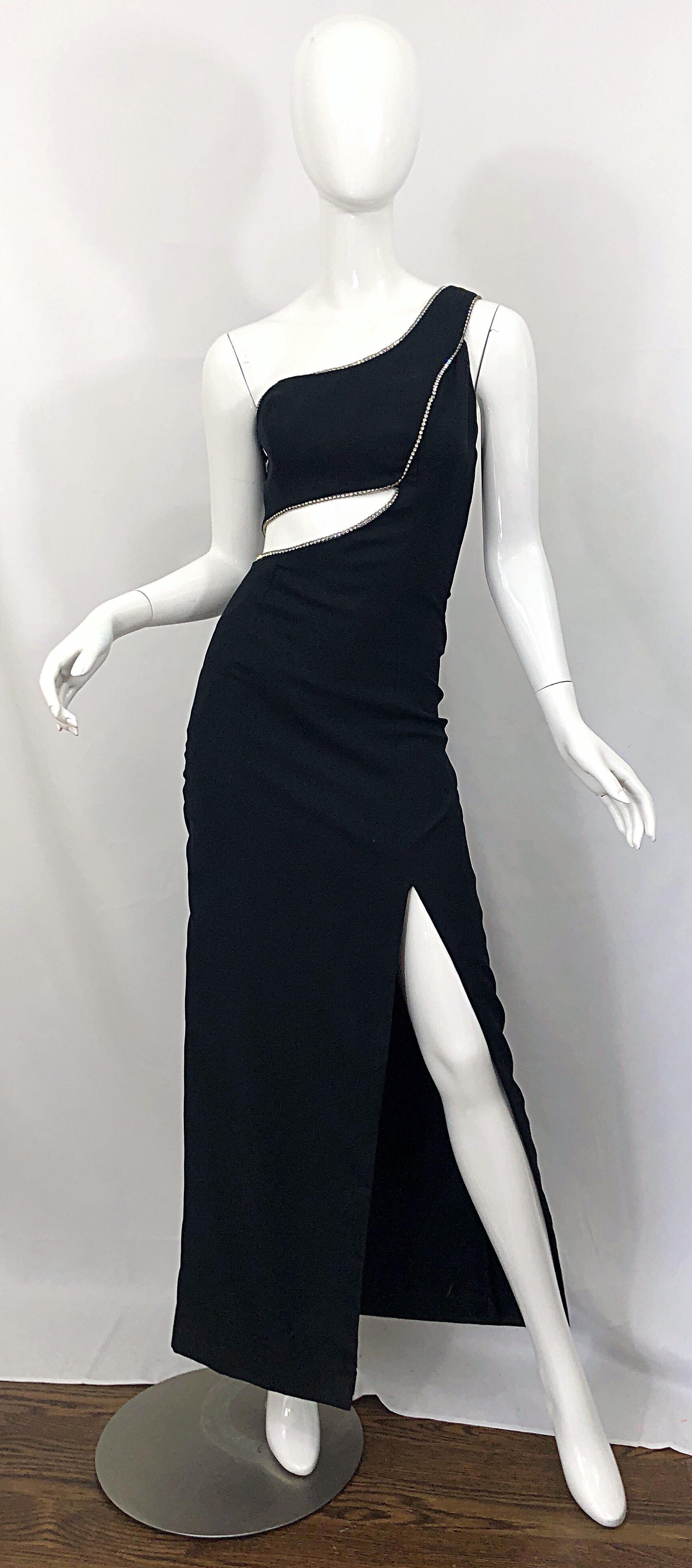 Sexy 1990s 90s black crepe rayon and rhinestone encrusted one shoulder cut-out Grecian evening gown! Very flattering, and super slimming!
Features a fitted one shoulder bodice, with cut-outs above the front and back waist. Hundreds of sparkly