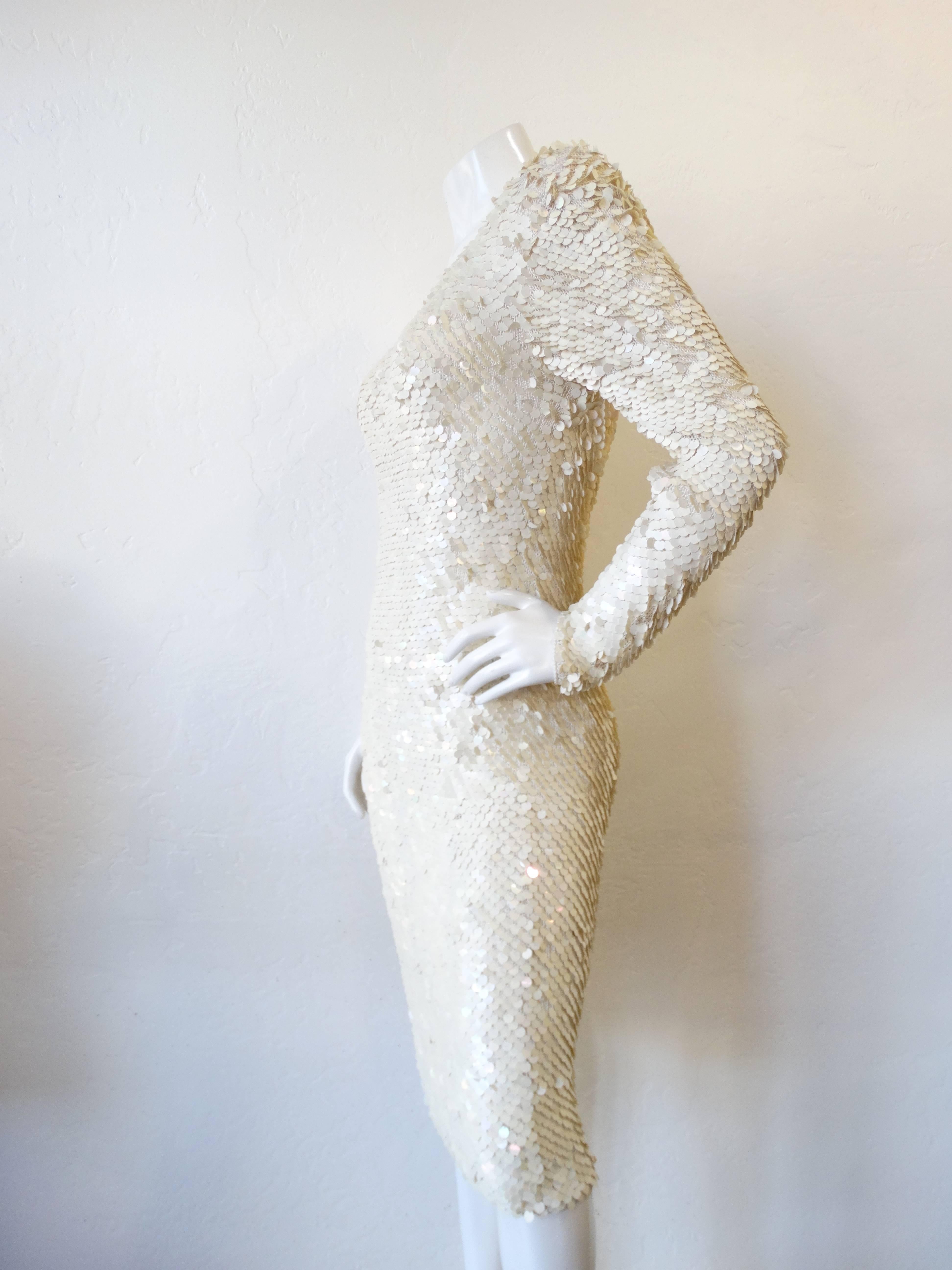 Nobody does sequins like vintage does! This piece is made of a creamy white knit and COVERED in pearlescent circle sequins. This dress hugs every curve perfectly, and dips in the back to show a little skin. The fabric has some stretch to it so it