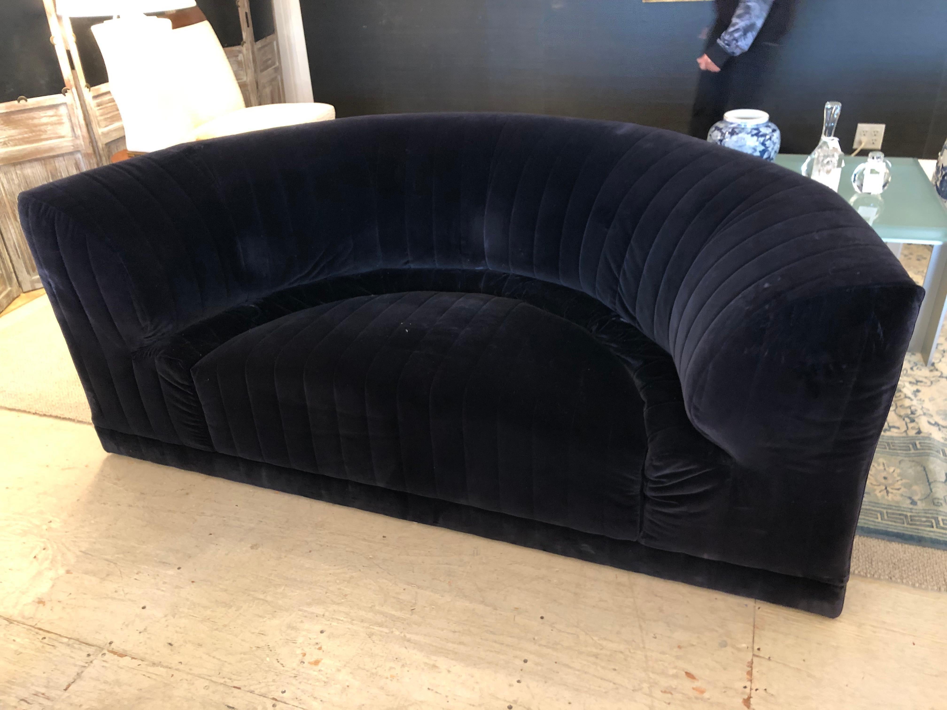 Elegant versatile size midnight blue velvet curvy loveseat by Roche Bobois. In the manner of De Sede, BB Italia, Mario Bellini, Camaleonda Sofa, and others. We also have the matching 8 piece sectional sofa available, but are selling the loveseat
