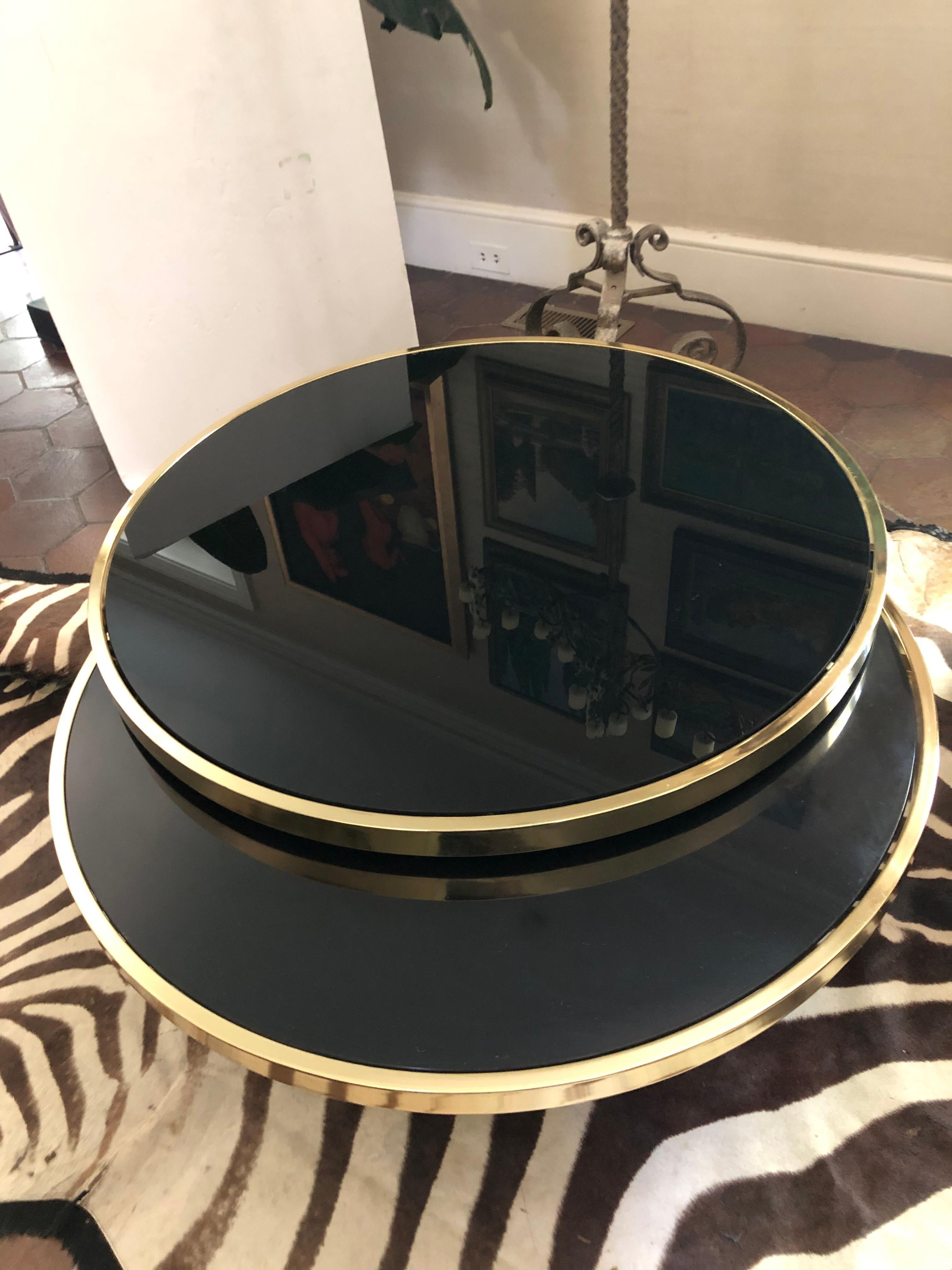Late 20th Century Sexy DIA Round Two Tier Swivel Brass and Black Glass Coffee Table