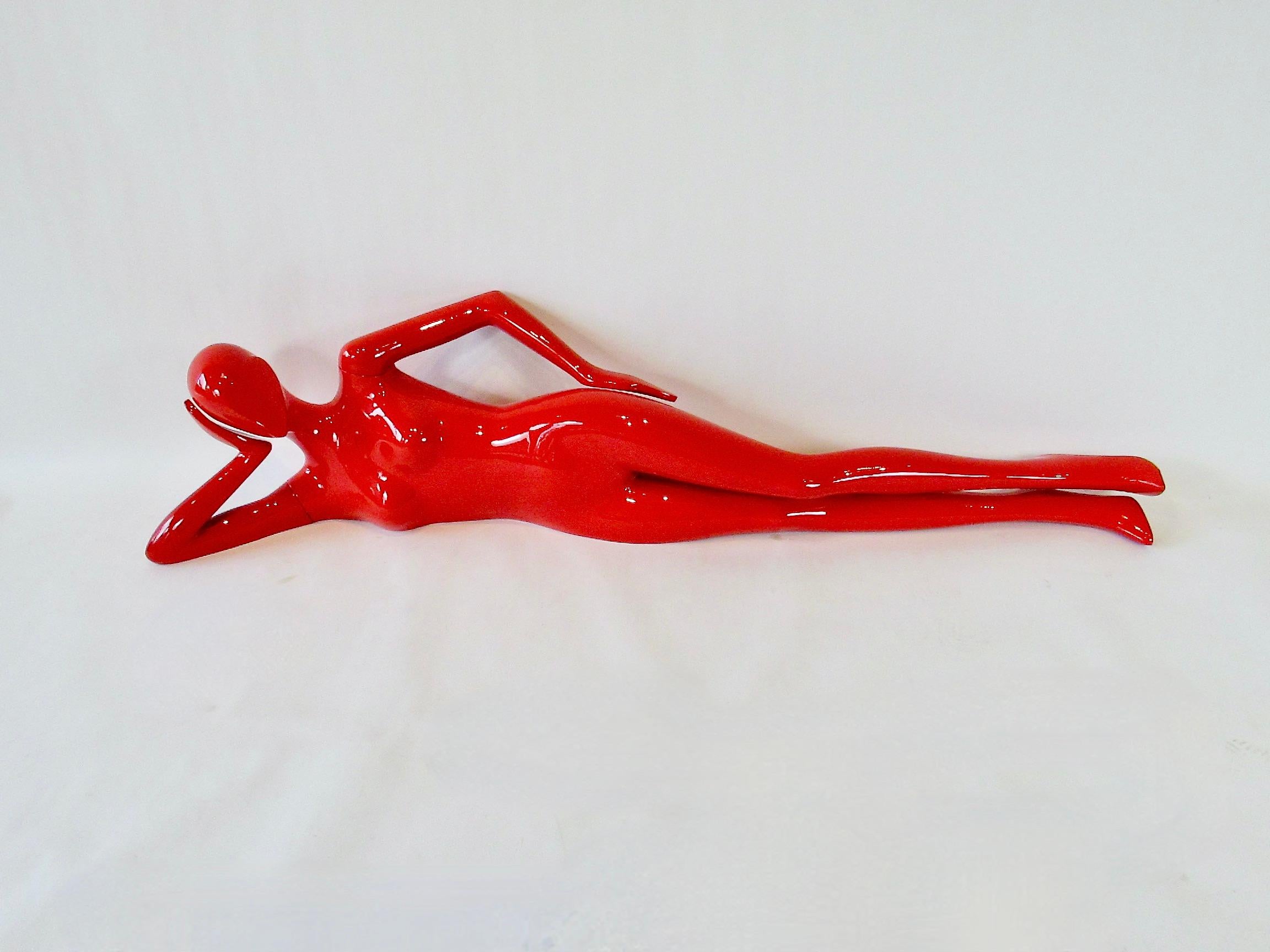 Long slender sexy female form mannequin . Designed in a head on hand reclined repose .  Finished in an extra glossy red base coat clear coat . About six feet long . Arms are removeable for shipping . 