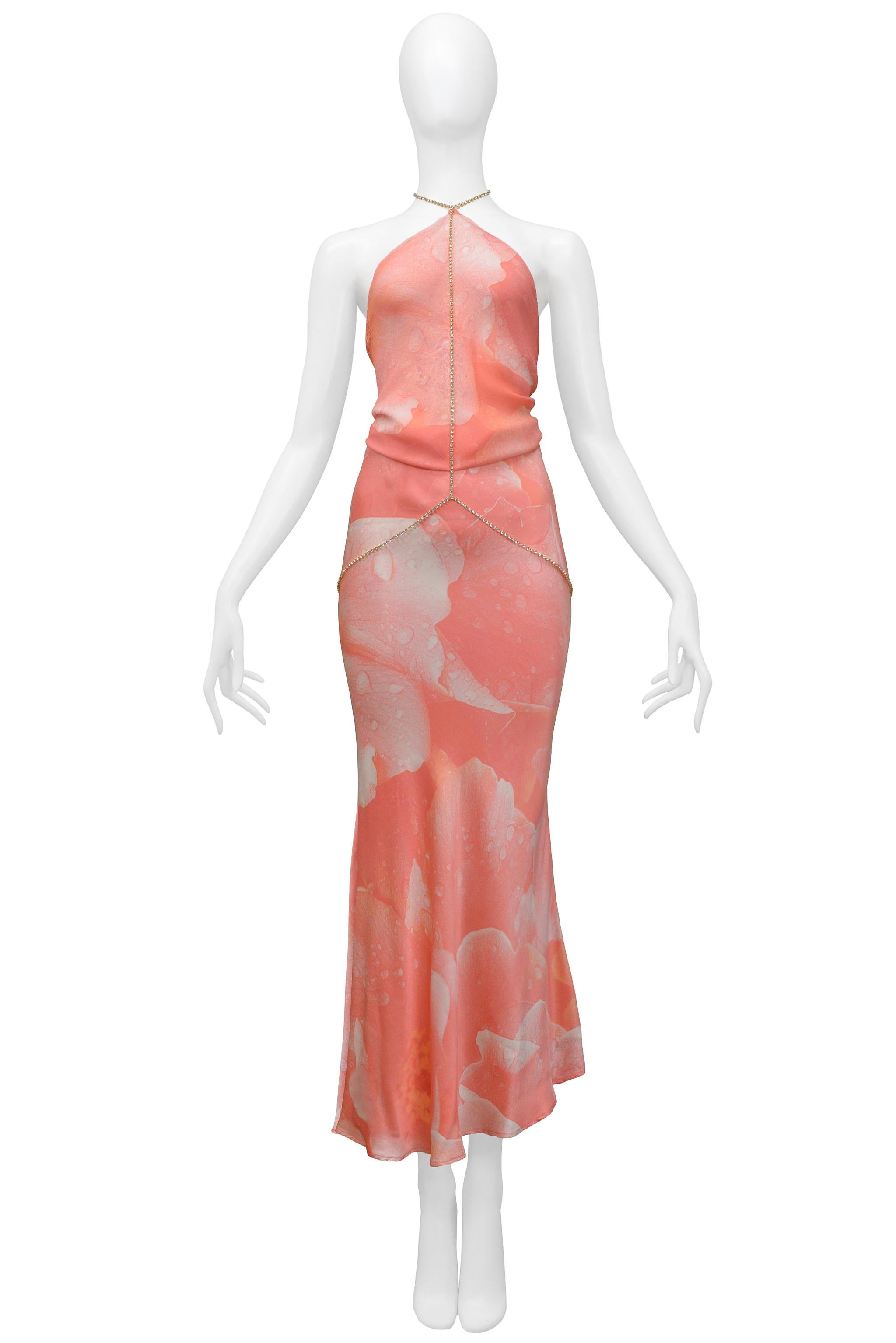 Resurrection Vintage is excited to present a vintage Roberto Cavalli pink printed evening gown featuring a halter neck and tie-back bodice, attached clear rhinestone with a gold-tone bezel belly chain, and uneven hem. 

Roberto Cavalli
Size: