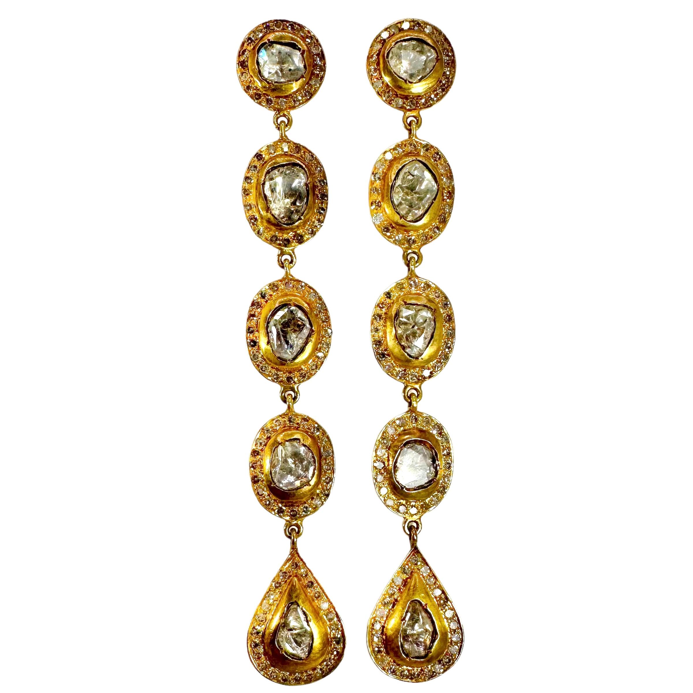 These fabulous vintage earrings were crafted in 18K yellow gold and set with various single cut diamonds surrounding larger rose cut diamonds in a halo type effect. The diamonds have a total approximate weight of 5.43ct with an overall J color and