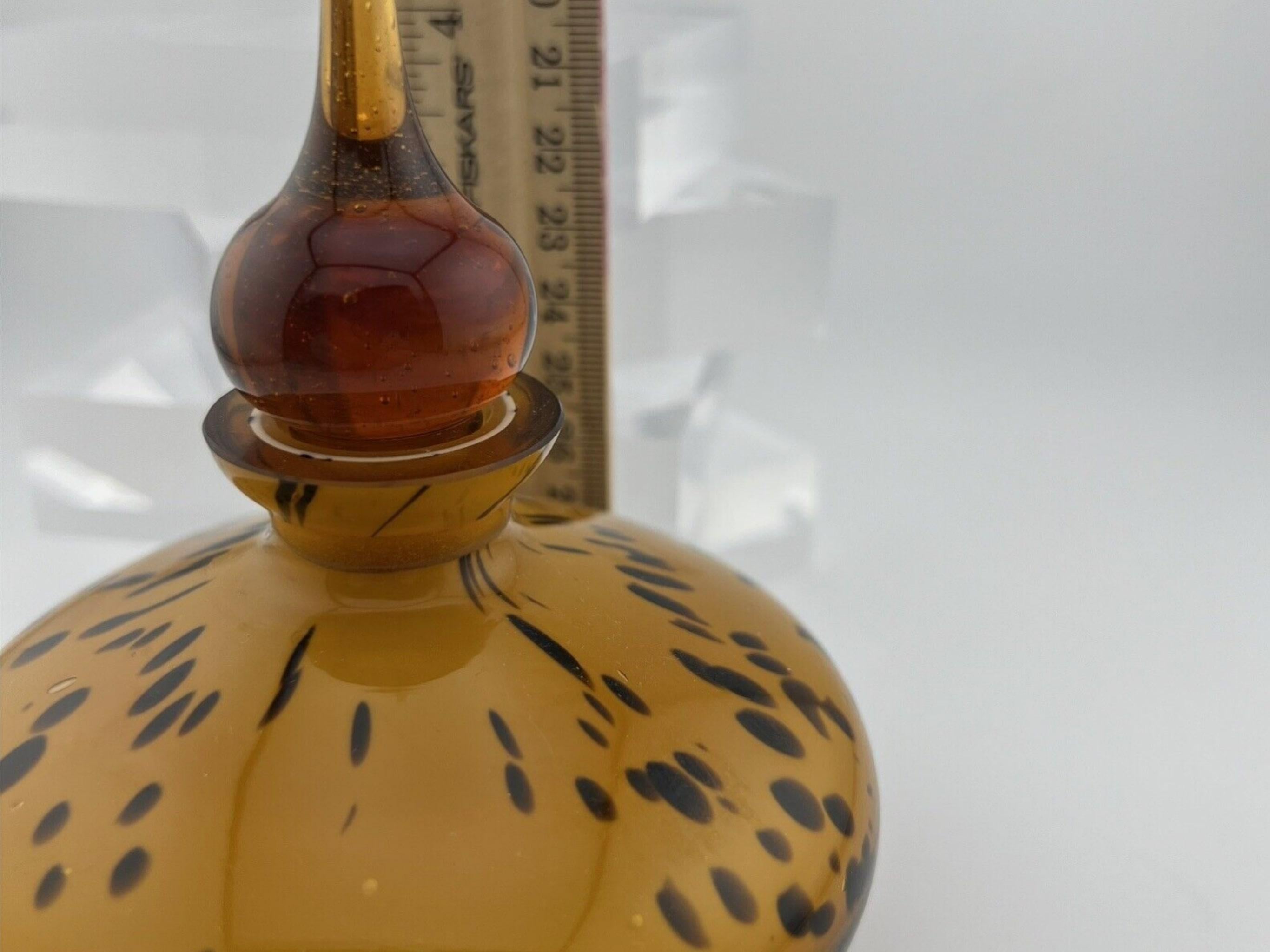 Sexy Vintage Murano Art Glass Amber Tone Leopard/Tortoise Design Perfume Bottle

Made in Italy 
Circa 1960s
In fantastic condition 
Mid Century Modern 
Murano 

Striking mid-century Rare Murano Art glass perfume bottle 
Murano glass. This striking