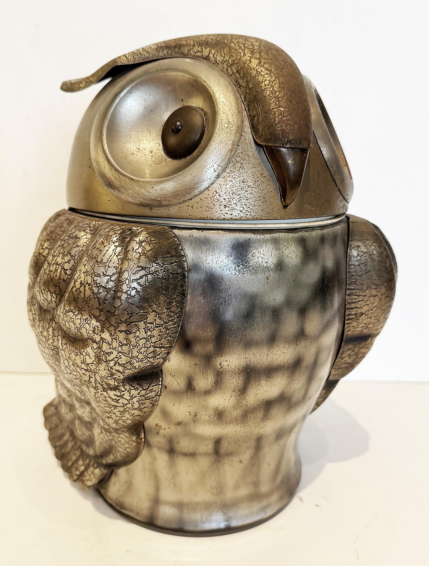 Seymour Mann Pewtertone Olde Tankardware Owl Ice Bucket from Japan

Offered or sale is a mid-century modern Pewtertone Owl ice bucket. The bucket has 
a patina with light scratches and pitting associated with wear and age use. The liner is clean and
