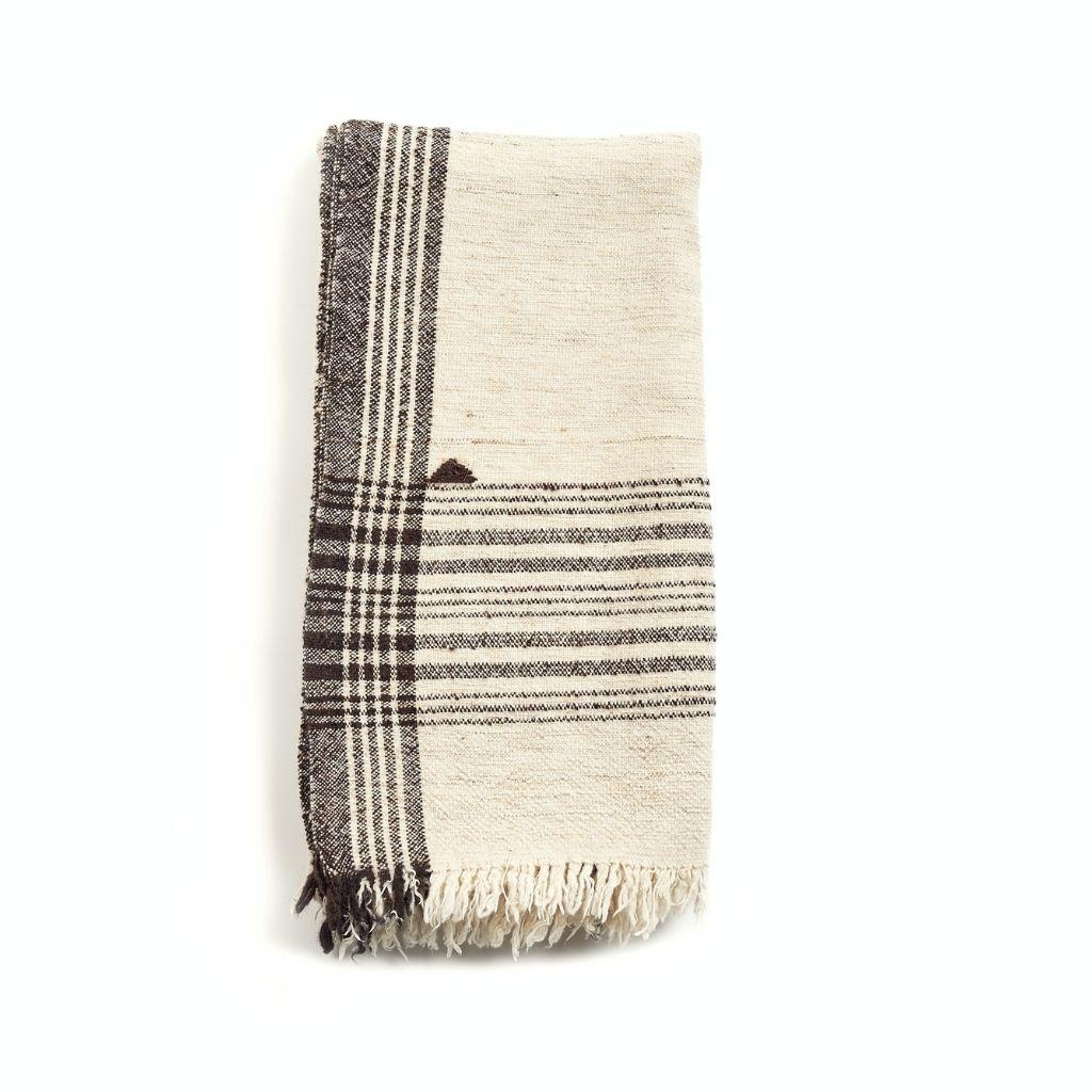 Seytu Throw is a slightly textured handwoven throw, where our artisans have skillfully blended handspun yarns like silk, wool and organic cotton. The beauty of this throw is in its pure design that stands out with the use of undyed yarns left in its