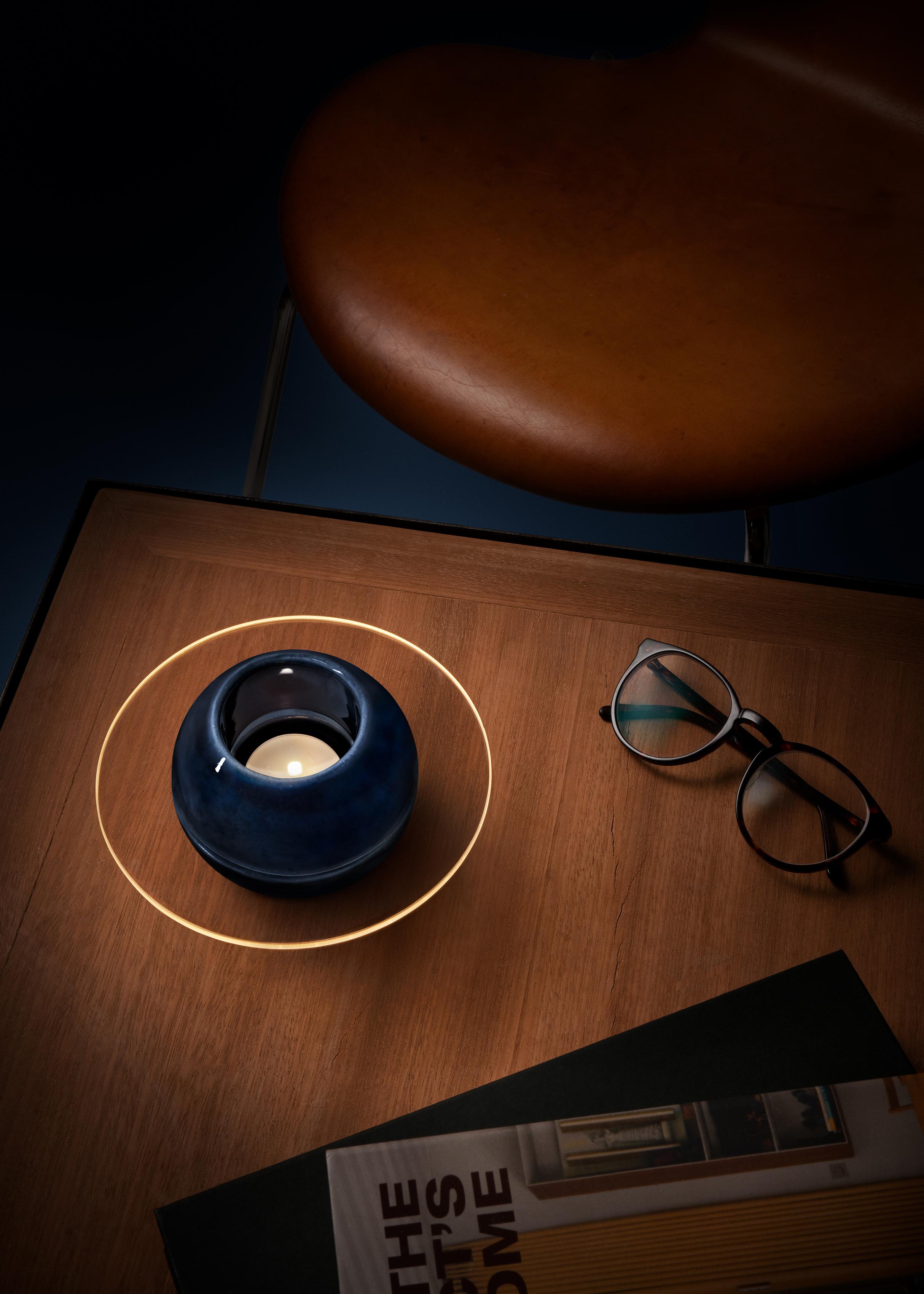 Sfär is a tealight holder composed of three parts. A two-part spherical shape in porcelain made in the porcelain factory in Lidköping, Sweden. A sheet of glass in between that is water-cut in Emmaboda, Sweden. The glass has a cut out hole on the