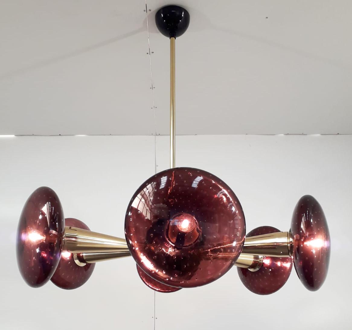 Italian chandelier with amethyst Murano glass shades hand blown with bubbles inside the glass using Bollicine technique, mounted on newly made polished brass frame with black enameled center and ceiling canopy / Designed by Fabio Bergomi for Fabio