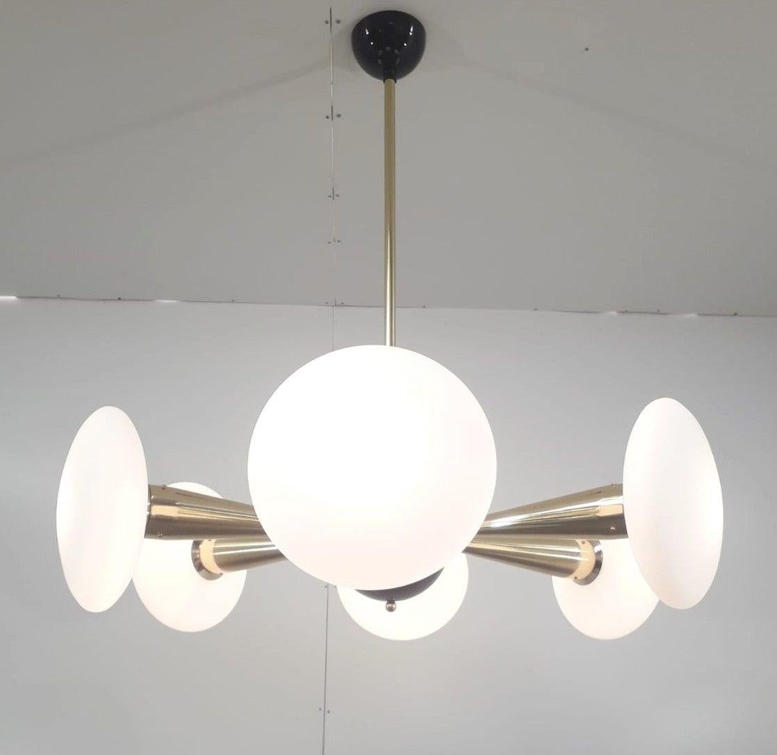 Italian chandelier with matte white Murano glass shades, mounted on newly made polished brass frame with black enameled center and ceiling canopy / designed by Fabio Bergomi for Fabio Ltd. / made in Italy.
6 lights / E12 or E14 type / max 40 W