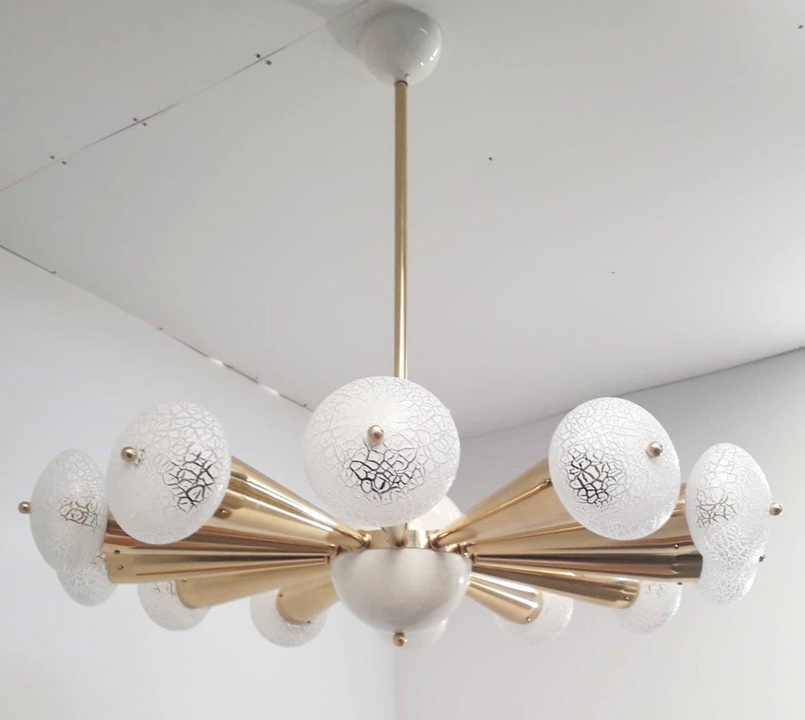 Italian chandelier with crackled frosted Murano glass orbs, mounted on polished brass frame with cream enameled center and ceiling canopy / Designed by Fabio Bergomi for Fabio Ltd / Made in Italy
12 lights / E12 or E14 type / max 40W each
Measures: