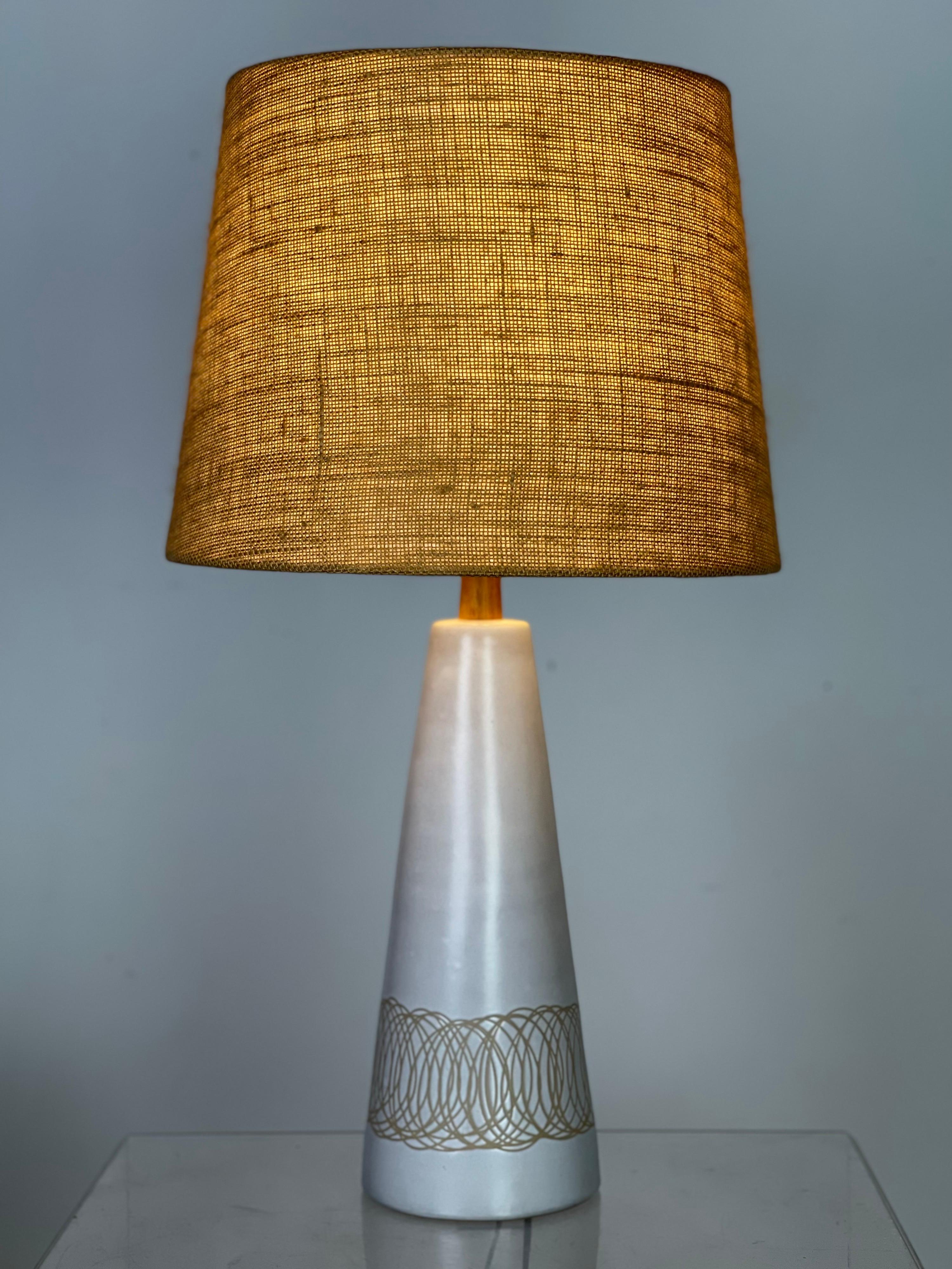 Lovely inverted cone shape lamp with the desirable incised sgraffito etchings/patterns by iconic lighting designers Jane & Gordon Martz for Marshall Studios. No chips or any issues. It has been rewired. Shade is not included. 
Measures: 29