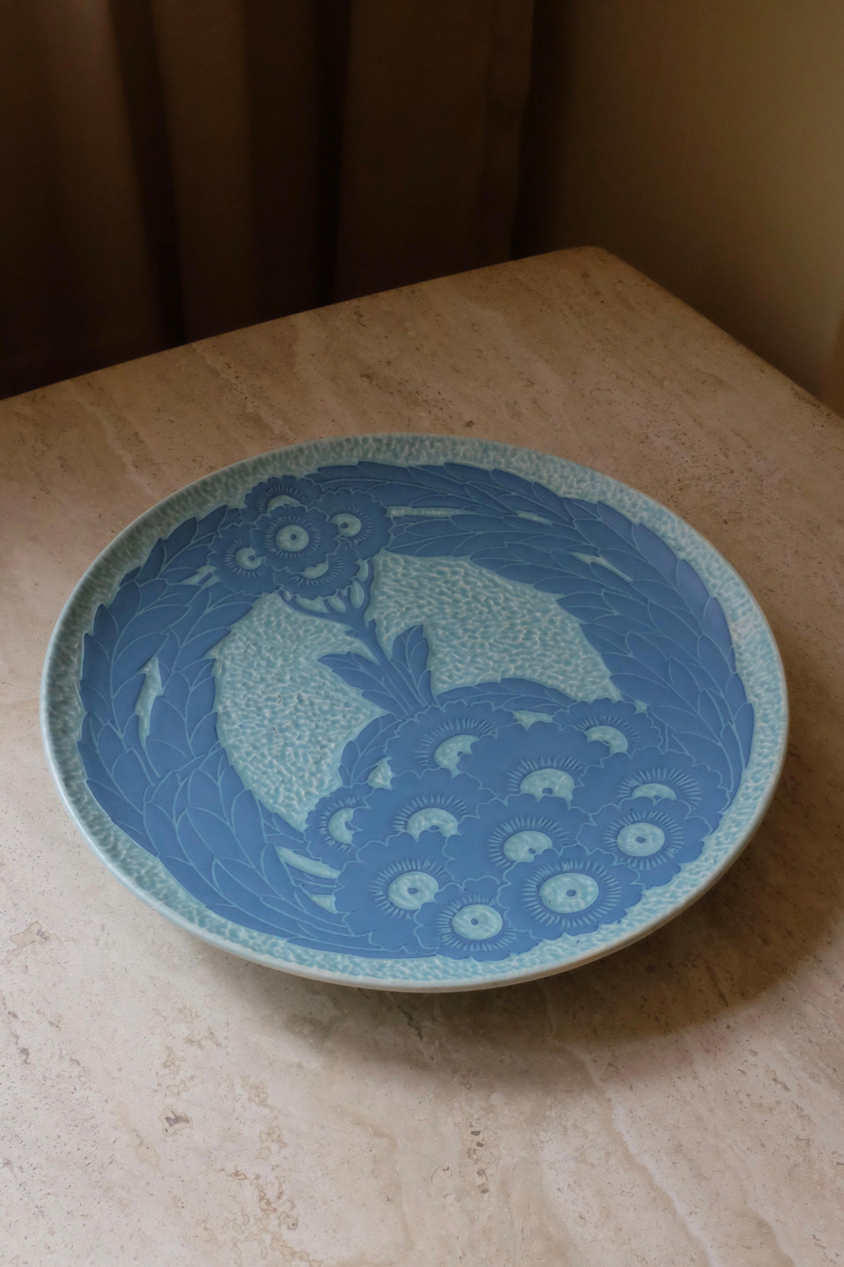 Blue Sgraffito plate from 1917 by Josef Ekberg for Gustavsberg, Sweden. Beautiful flower motif in Swedish Jugend (or Art Nouveau) style. The artist signature is visible at the bottom with the year 1917 and Gustavsbergs name. In great vintage