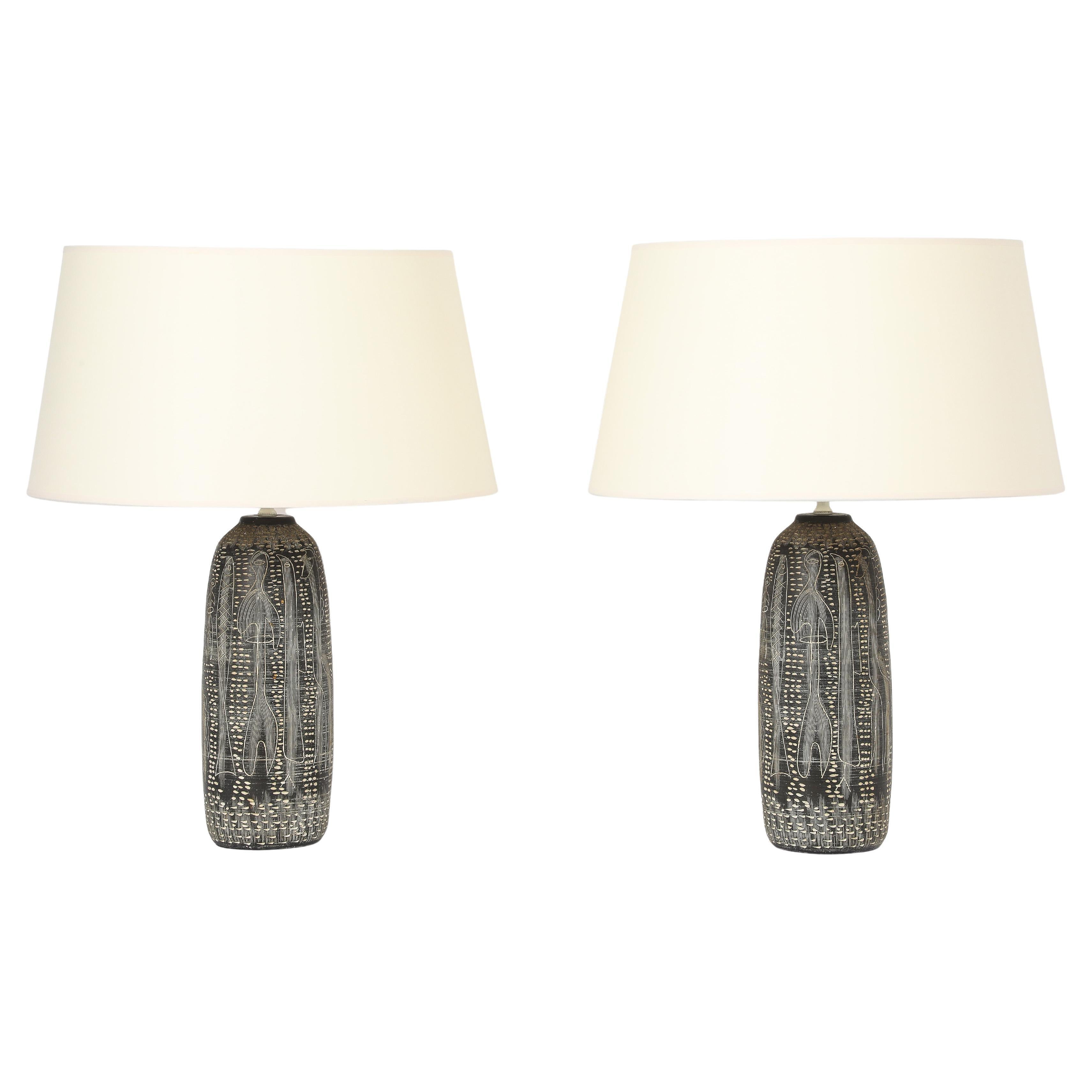 Pair of Italian studio lamps with delicately White incised abstract animal motifs with a matte glaze. Size of Base Only, wired.