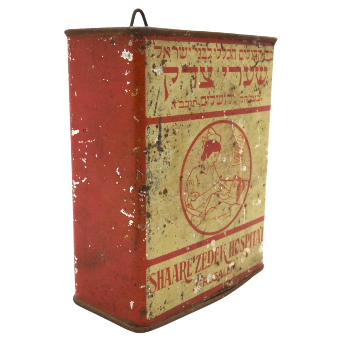 A charity container for the Sha'arei Tzedek Hospital designed by Alfred Saltzman from Jerusalem in 1930 reflects the efforts to support healthcare and charitable initiatives in the early 20th century.

Sha'arei Tzedek Hospital, founded in 1902 in