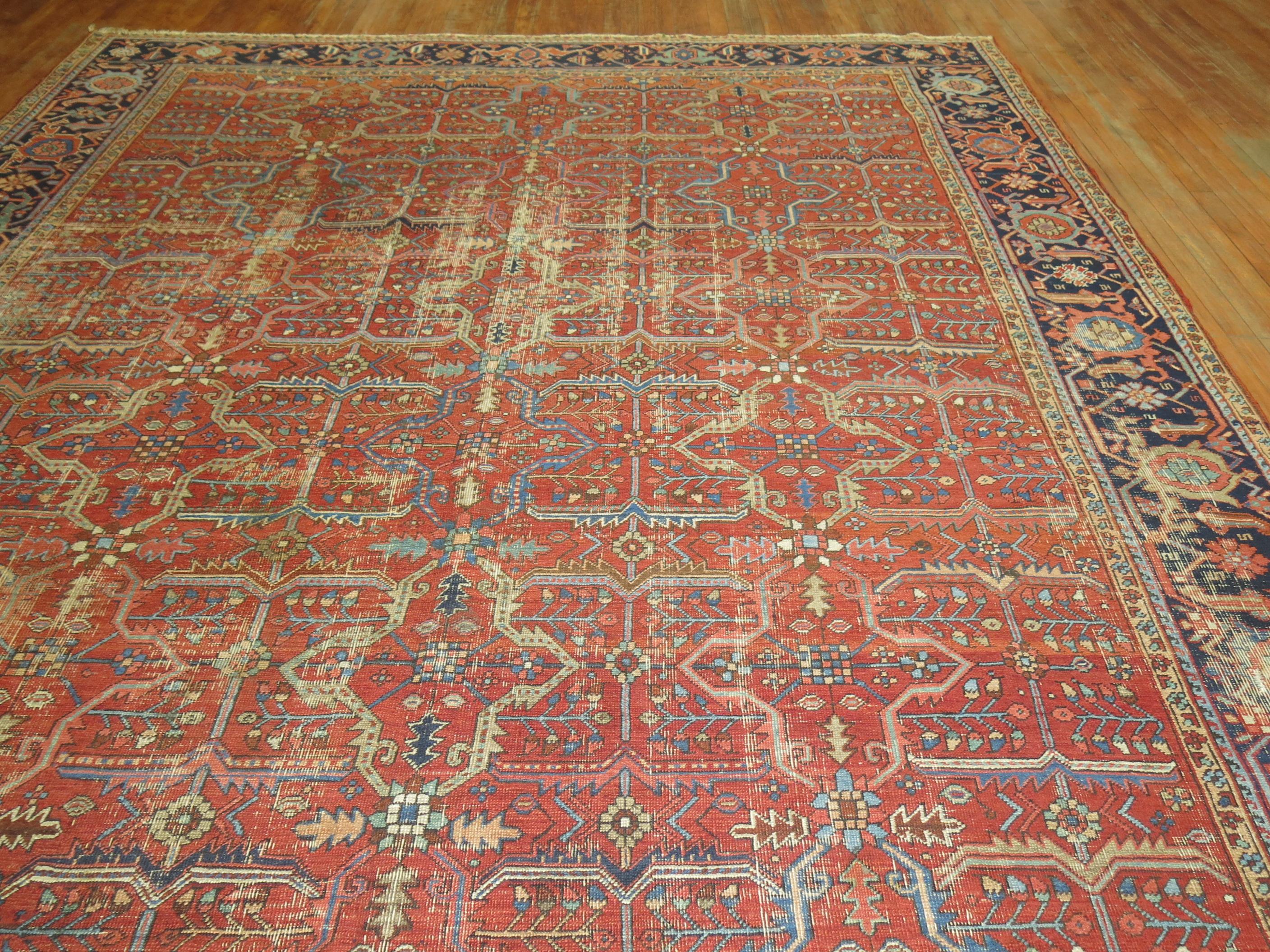 Room size shabby chic Persian Heriz rug featuring an all-over design in predominant rust tones.