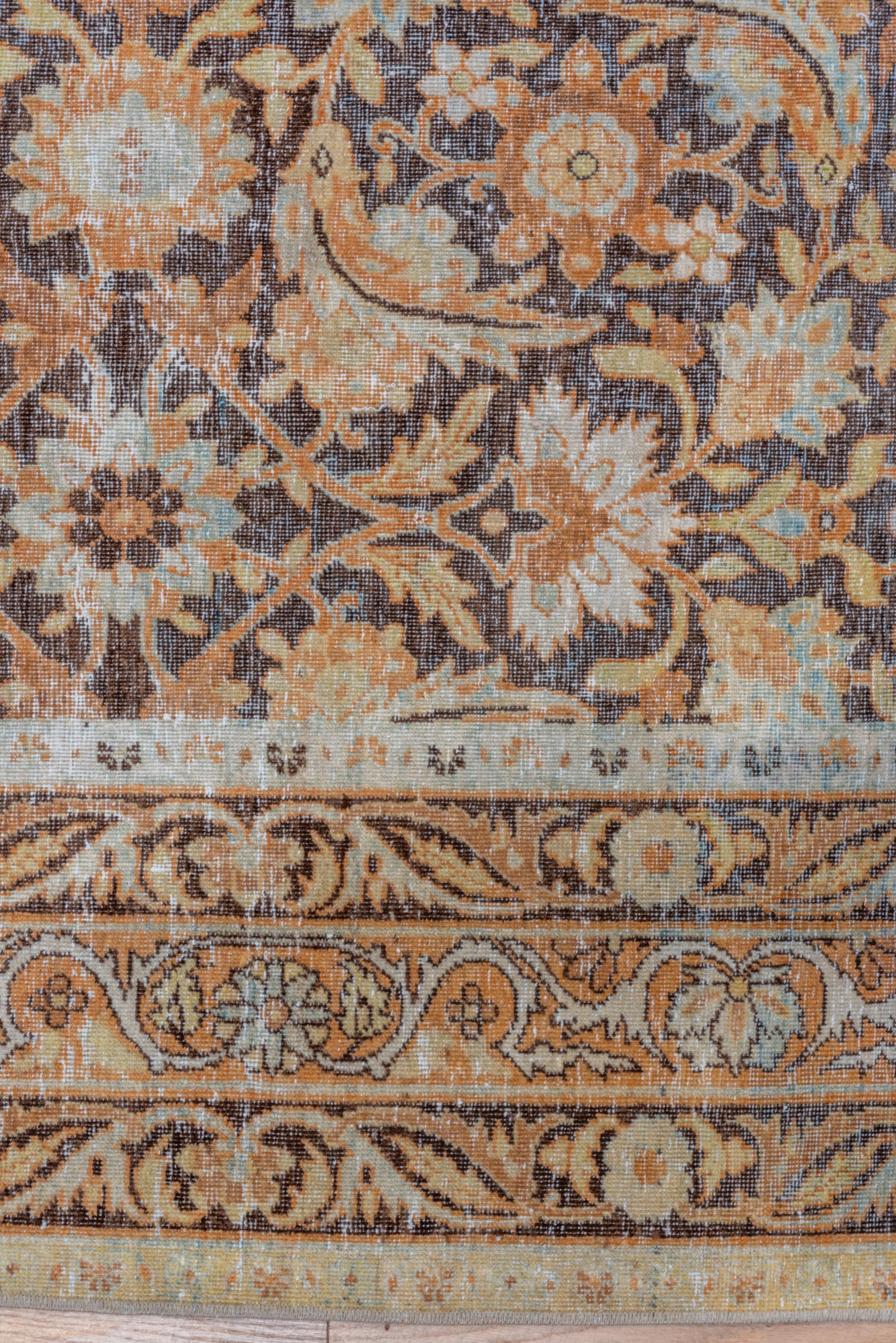 This Kerman actually employs, with some modifications, a Classic Persian carpet pattern. Here the popular Herati design is partially layered on the rich red ground. Similar narrow borders in red and pistachio, with forked leaves and rosettes or