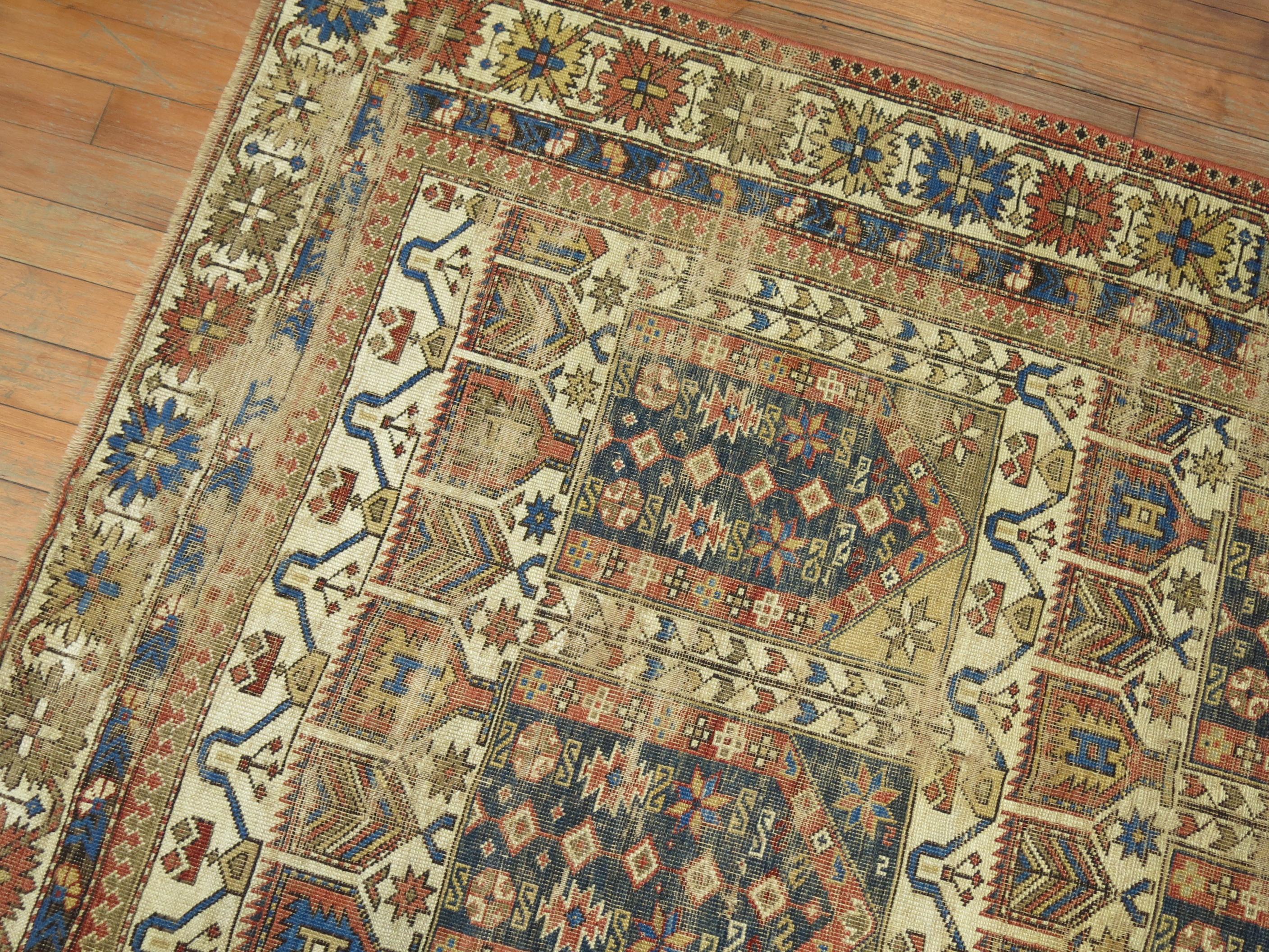 Throw size worn late 19th century Caucasian 3 x 5 rug in earthy palette. Rust, navy, Classic cluue, ivory. The wear is even throughout,

circa 1910, measures: 3'7
