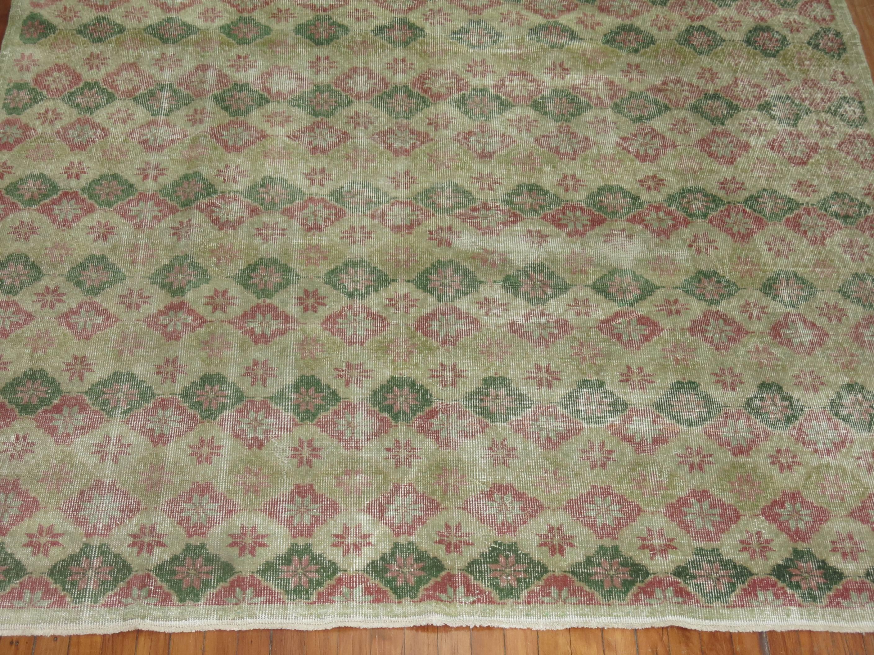 Room size Turkish deco rug with a repetitive square design throughout in feminine colors.