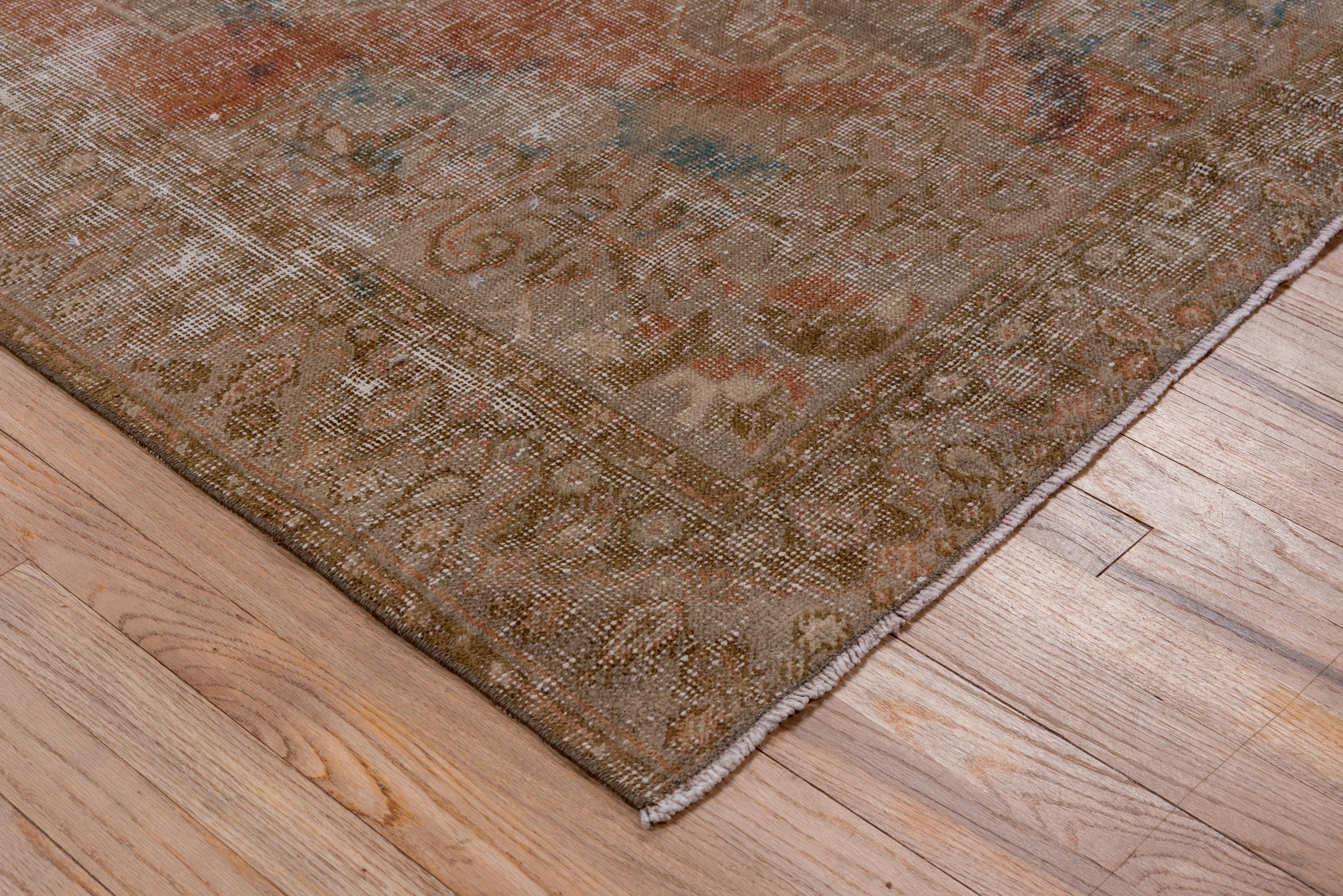 This scatter Oushak shows the remains of a medallion, pendants and corners, and an equally worn main border. The light foundation adds an additional cloud-like tone. Rustic palette. Orange field.