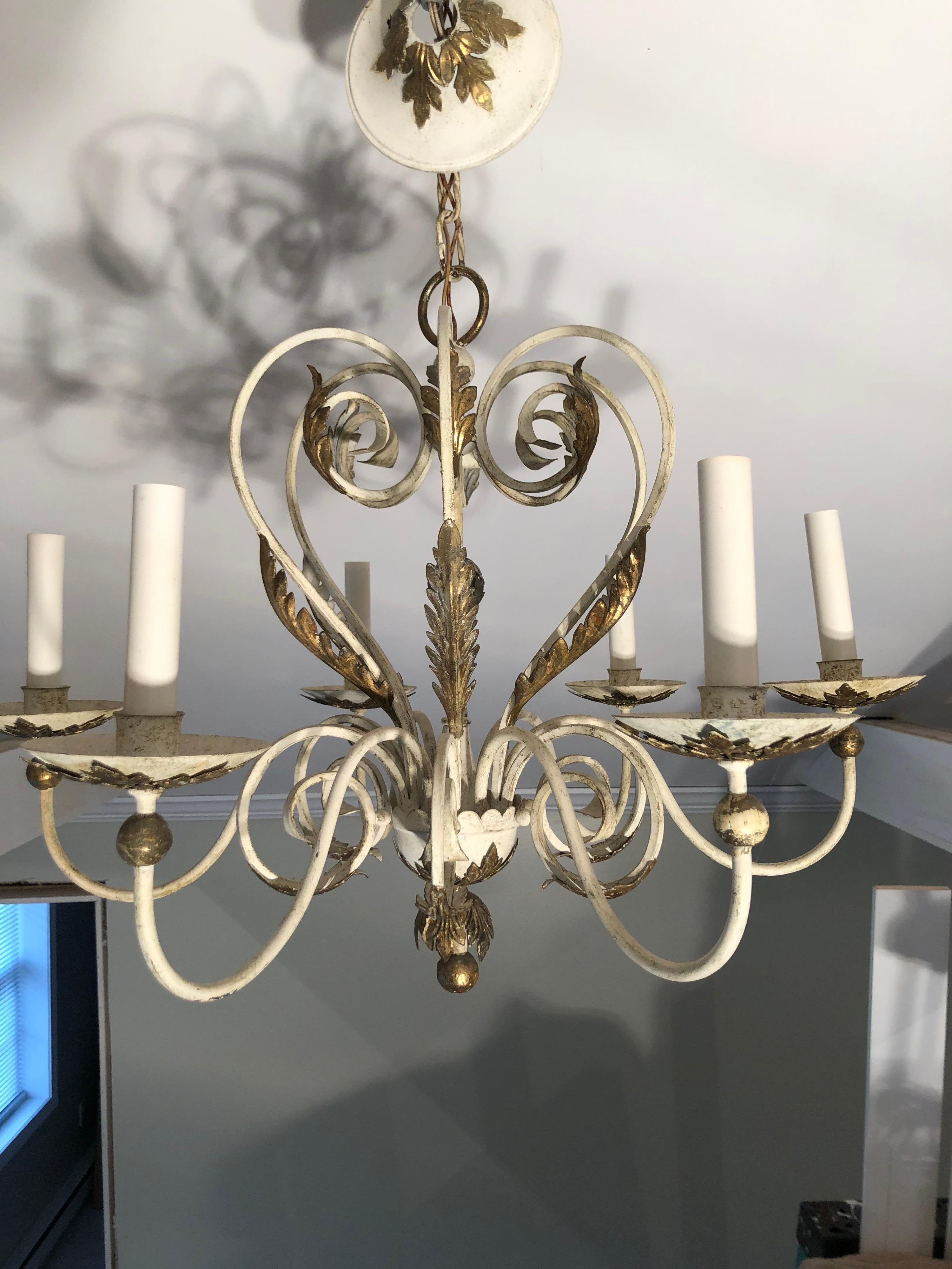 Shabby chic white and gold washed chandelier. Gorgeous six-arm electrified chandelier accented with gold acanthus style fern leaves. This item should parcel ship for $45
