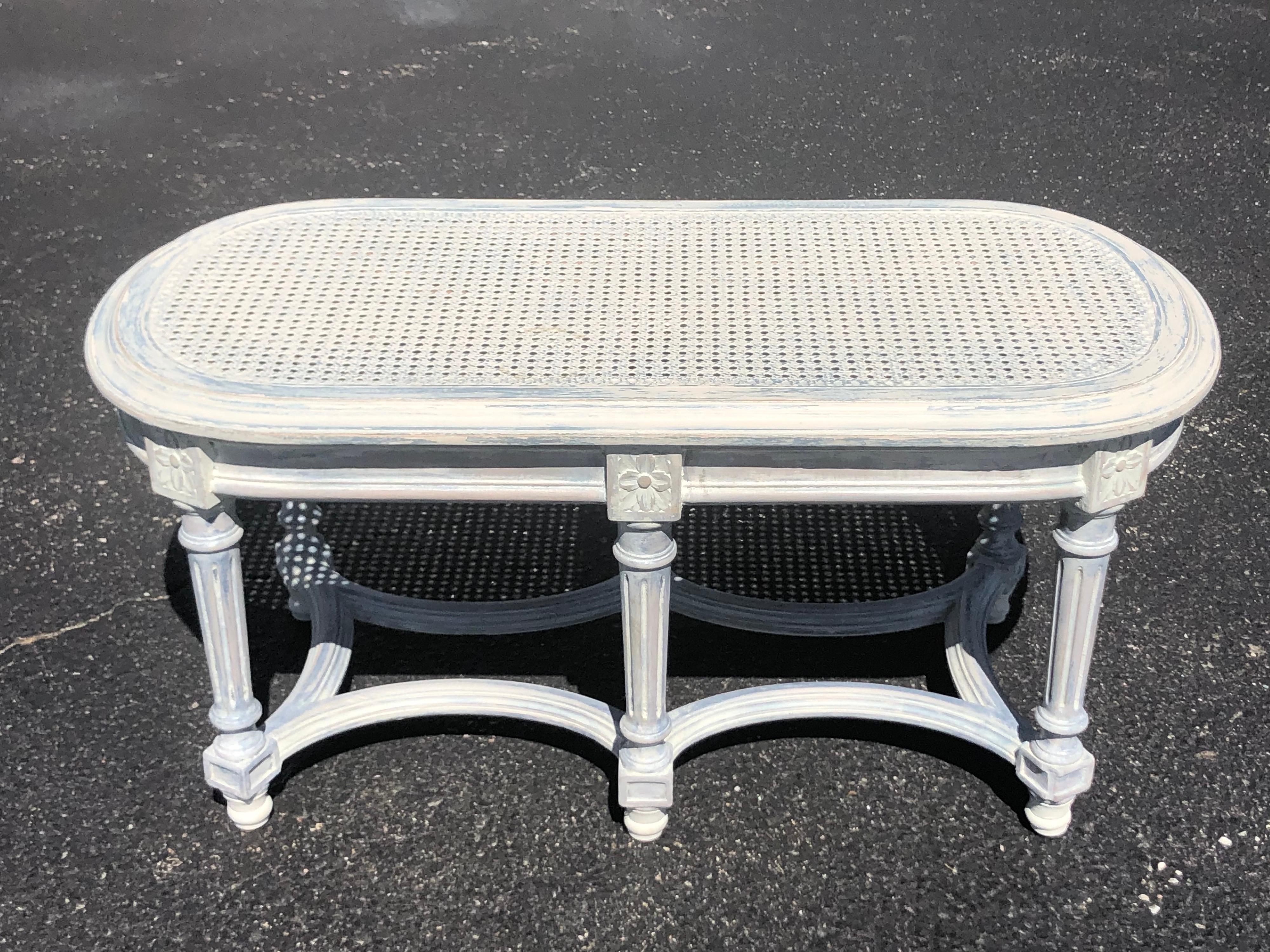 Shabby chic whitewashed cane bench. Perfect accent piece for that bedroom. French provincial in style. Use at the foot of a bed or under a windowsill. Or use as a nice oval coffee table. This item can parcel ship.