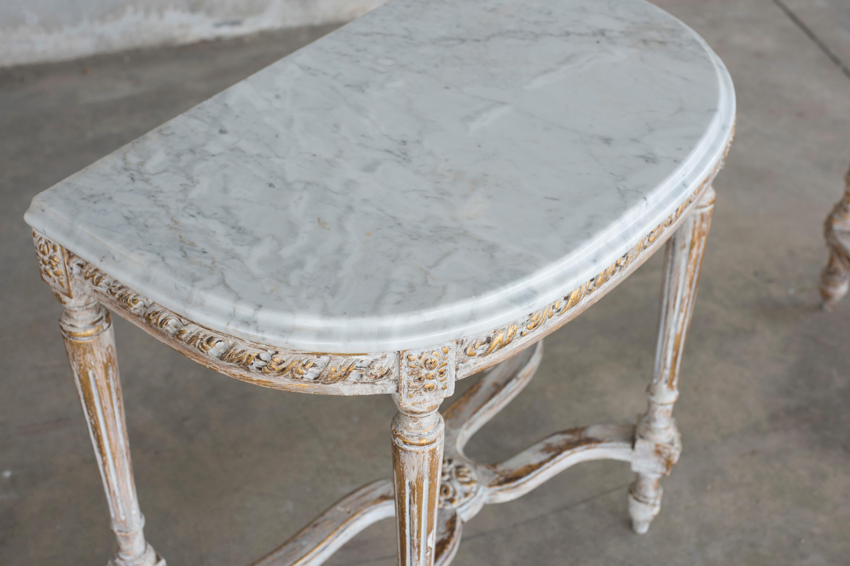 Pair of White lacquered Shabby Effect console tables with marble top in Louis XVI style.
Size of each table: W 65 cm, D 40 cm, H 63 cm.
Restored in conservative way.
Wood structure is in pinewood light wood. The marble is white Carrara marble.
A